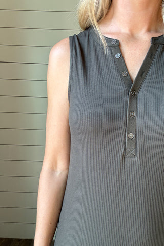 &nbsp;Effortless and flattering, this sleeveless knit dress is the perfect blend of comfort and style. Made from a soft, stretchy ribbed fabric, it skims the body without feeling tight. The henley-style button front adds a casual touch, while the midi length and side slit keep it versatile and easy to move in. Pair it with sandals for an easy day look or layer with a denim jacket for cooler evenings.