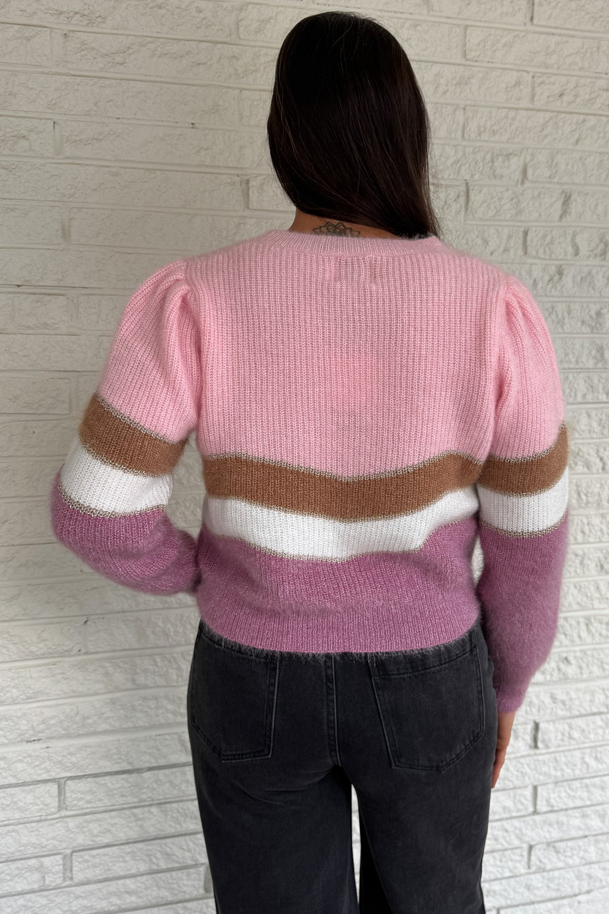 Soft and playful, this zigzag striped sweater adds a cheerful pop of color to your fall lineup. Designed with subtle shoulder gathers and a touch of shimmer in the thread, it blends comfort with a hint of fun. The mix of pink, ivory, and taupe tones makes it an easy piece to dress up or keep casual.
