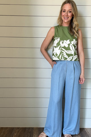 Breezy and effortlessly chic, this sleeveless floral-print top is a perfect blend of structure and ease. With an outer shell that is crafted from100% cotton, it features a fully lined lightweight interior for a polished finish and comfortable wear. The vibrant green base is accented with a bold white floral pattern, bringing a fresh, botanical touch to your wardrobe.