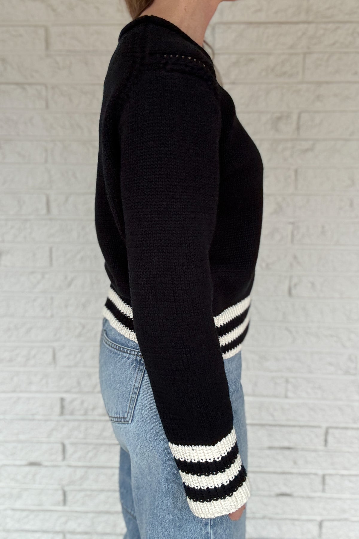 This classic striped knit is the kind of sweater you’ll wear all season long. Made from a heavy 100% cotton knit, it has a cozy, substantial feel without being bulky. The contrast stripes at the hem and cuffs add a clean, sporty touch that keeps it timeless and easy.
