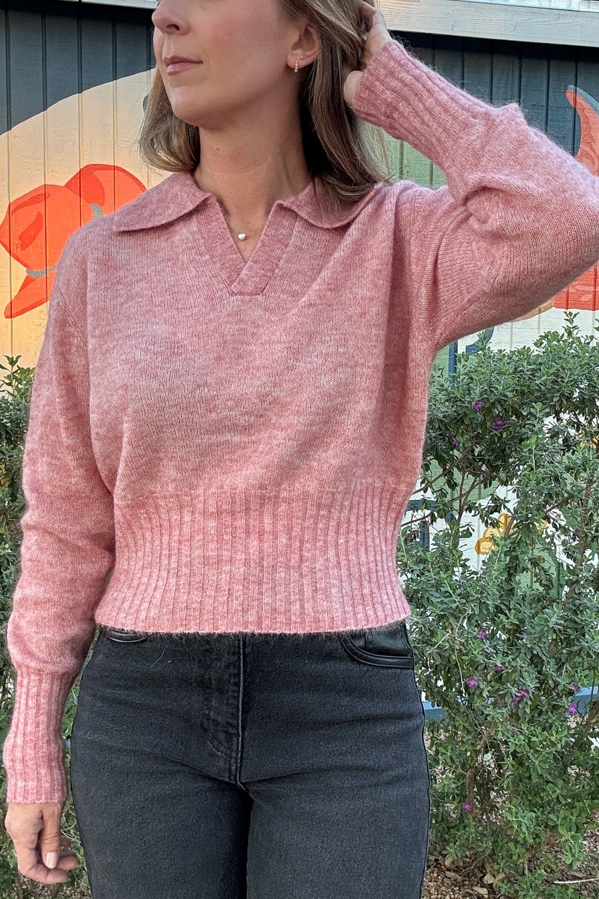 Women's heather pink collared knit sweater with a flattering slightly cropped silhouette and cozy long sleeves. Styled with black denim at Cotton & Cashmere in Blanco, Texas.