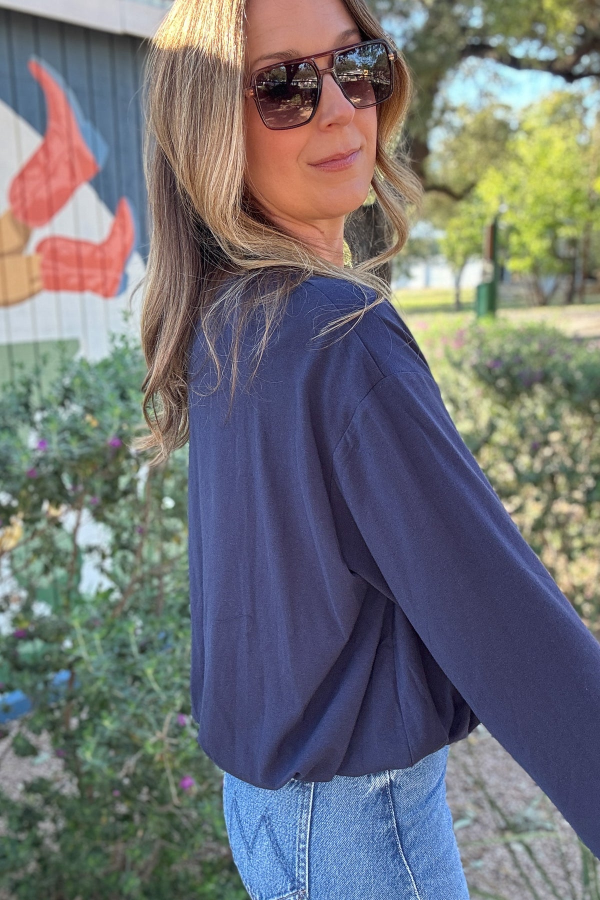 Women's relaxed fit navy crewneck top styled with light wash jeans for an effortless casual outfit. Shop Cotton & Cashmere in Blanco, Texas.