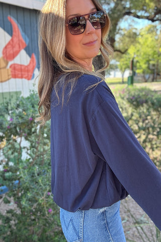 Women's relaxed fit navy crewneck top styled with light wash jeans for an effortless casual outfit. Shop Cotton & Cashmere in Blanco, Texas.
