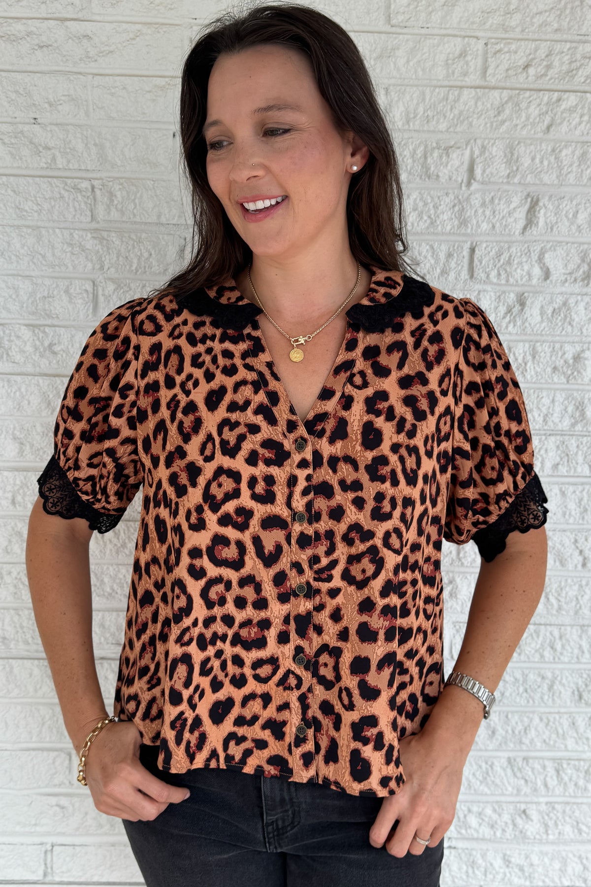 &nbsp;This leopard print blouse is bold and feminine with playful details. A black lace collar and matching lace trim on the puff sleeves give this classic print a chic update. Lightweight and easy to wear, it’s perfect for dressing up denim or pairing with tailored pants.