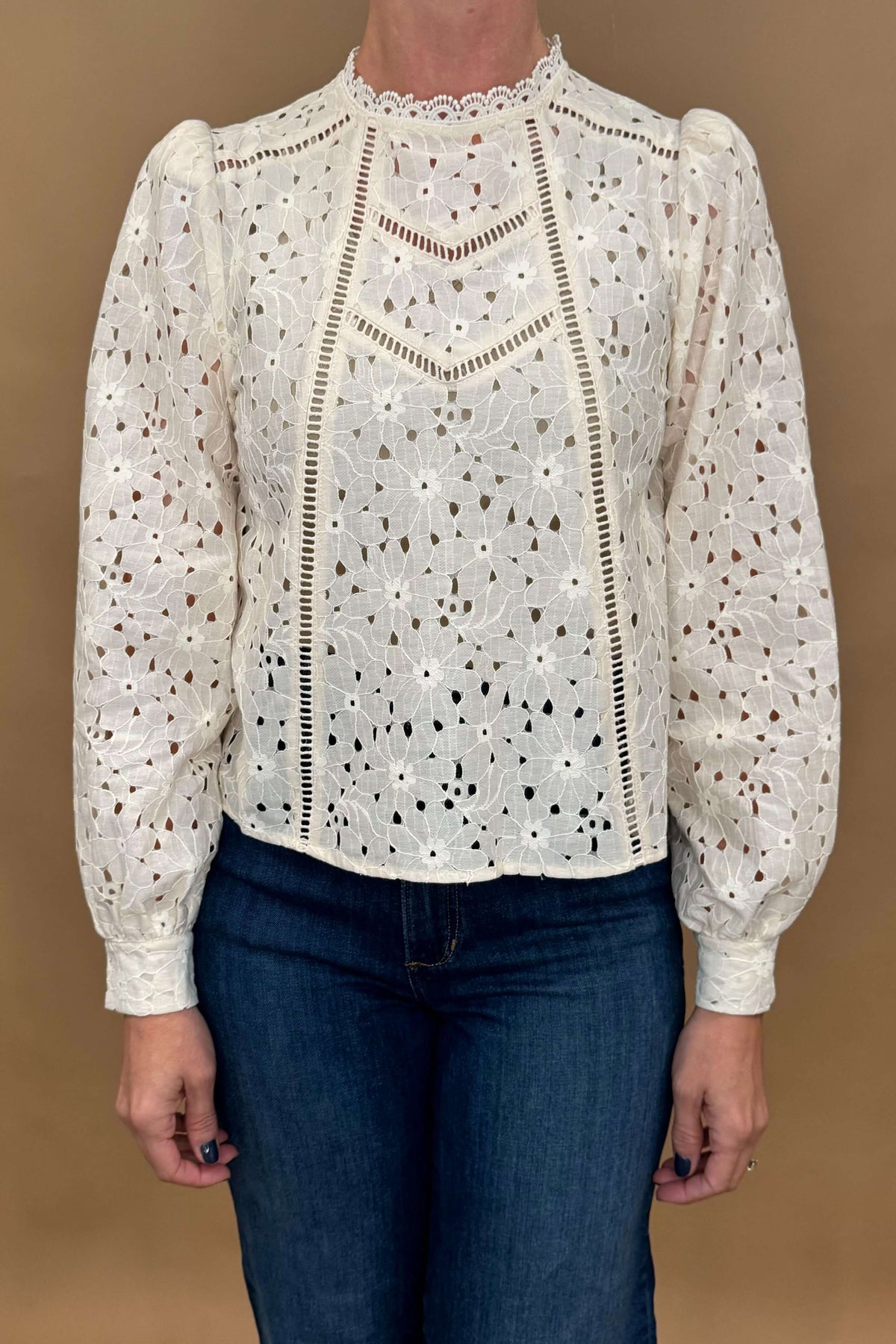 The Lais Blouse exudes elegance with its open lace detailing and feminine design, perfect for any occasion. Made with high-quality fabric and designed in France, this cream-colored blouse will elevate any outfit. The delicate lace neckline adds a touch of sophistication, while the layer able style offers versatility. Embrace the flattering blouse fit and stand out in style.