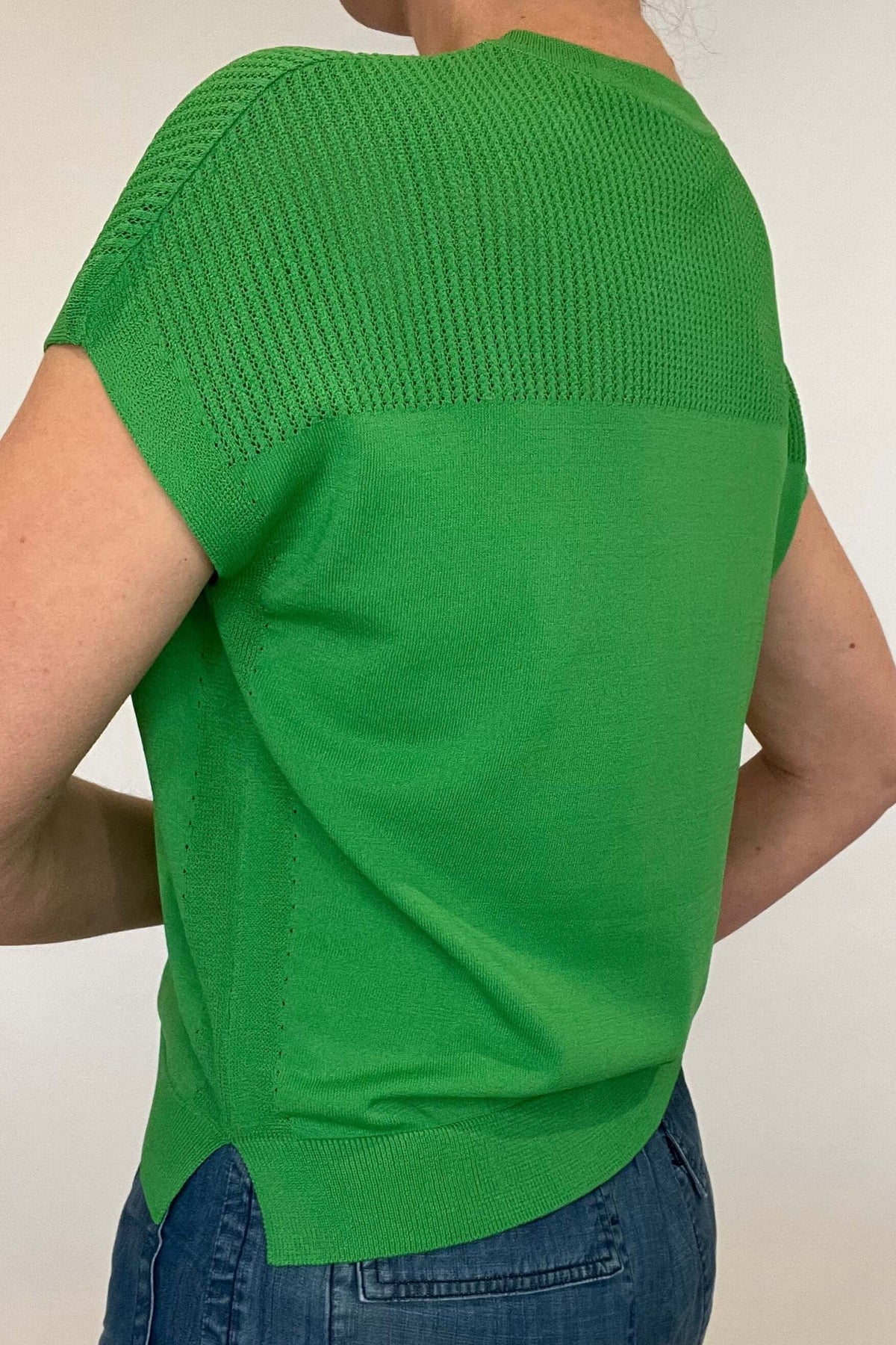 Elevate your spring style with our Laser Cut Summer Sweater. The open weave design over the shoulders and upper chest adds a touch of lightness to this vibrant and chic piece. With color options in grass green and bright orange, pair it effortlessly with chambray pants or white denim for a stylish look.