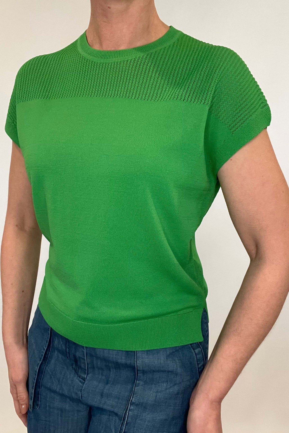 Elevate your spring style with our Laser Cut Summer Sweater. The open weave design over the shoulders and upper chest adds a touch of lightness to this vibrant and chic piece. With color options in grass green and bright orange, pair it effortlessly with chambray pants or white denim for a stylish look.