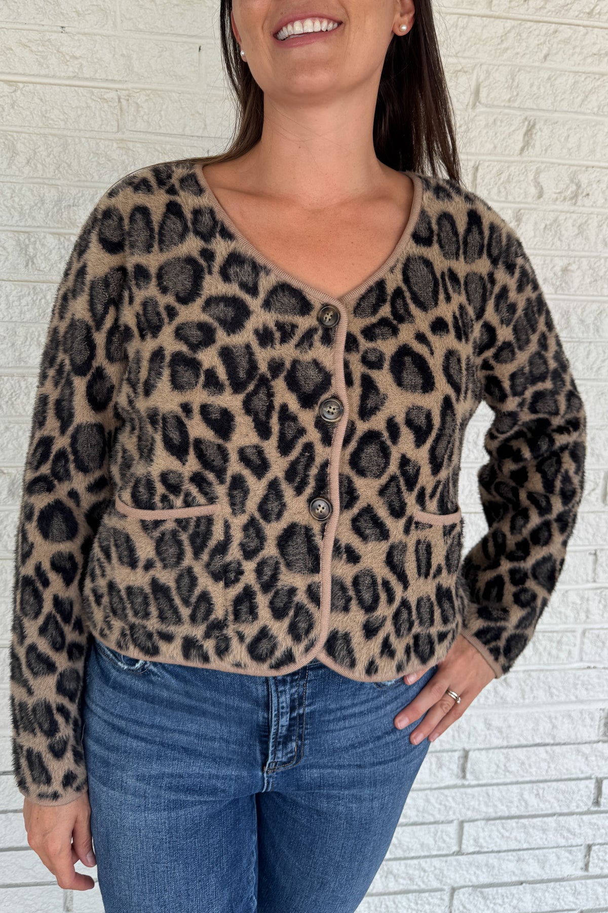 Add a playful pop to your wardrobe with this fuzzy leopard print cardigan. Made from a soft poly blend, it’s cozy with a touch of fun, featuring a button front, front pockets, and a cropped fit. A statement layer that still feels effortless for everyday wear.