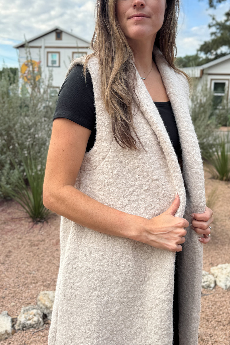 &nbsp;Polished yet effortless, the Long Line Fuzzy Vest brings a modern twist to classic layering. Designed in the same textured finish as the Bronte, it features a sleeveless silhouette with a relaxed, tailored drape, perfect for transitional weather or elevated everyday wear. The open front and single button closure make it easy to dress up or down.