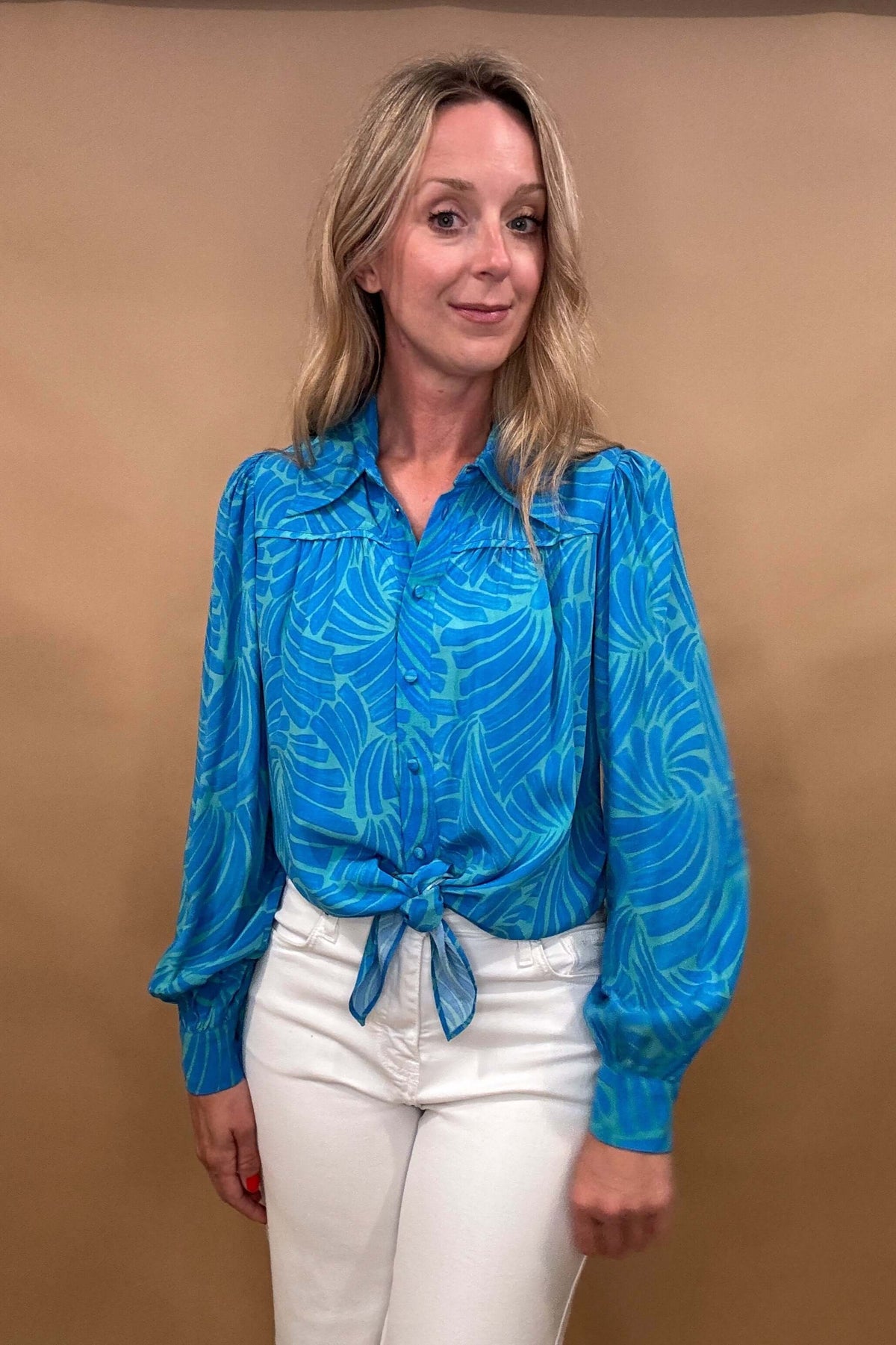 Elevate your wardrobe with our Luna Blouse in Blue.

The striking color palette and unique tie waist design make this blouse a statement piece.

Impeccable detailing and a banded back allow for a flattering billowing effect. Take your style to the next level with this luxurious and sophisticated top.