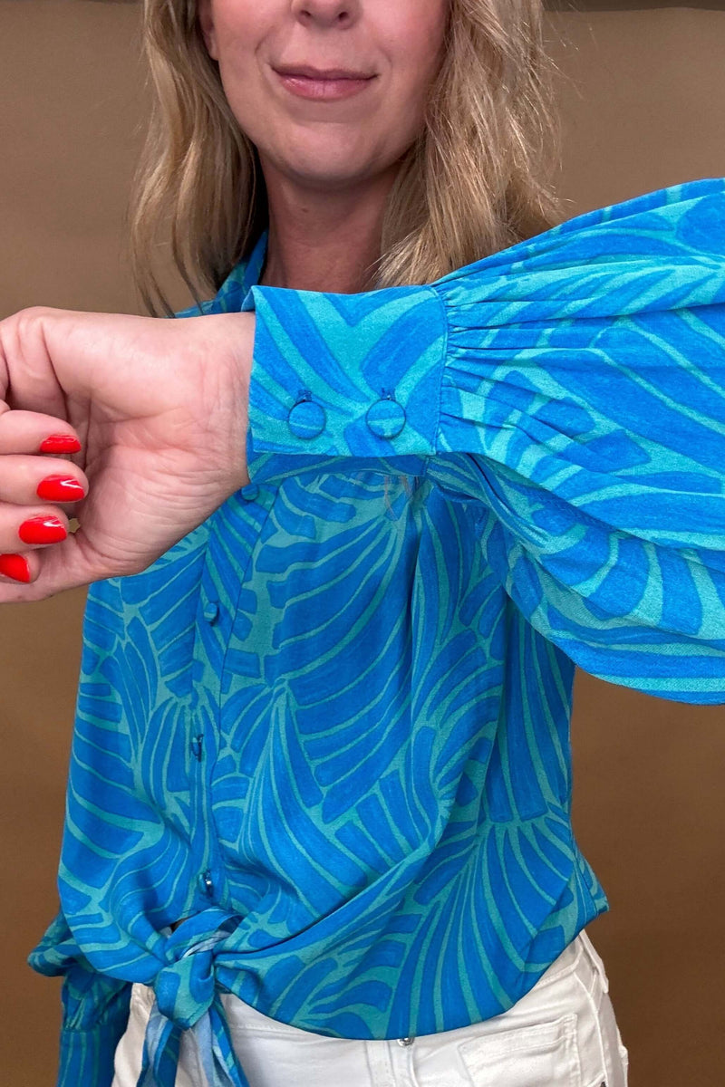 Elevate your wardrobe with our Luna Blouse in Blue.

The striking color palette and unique tie waist design make this blouse a statement piece.

Impeccable detailing and a banded back allow for a flattering billowing effect. Take your style to the next level with this luxurious and sophisticated top.