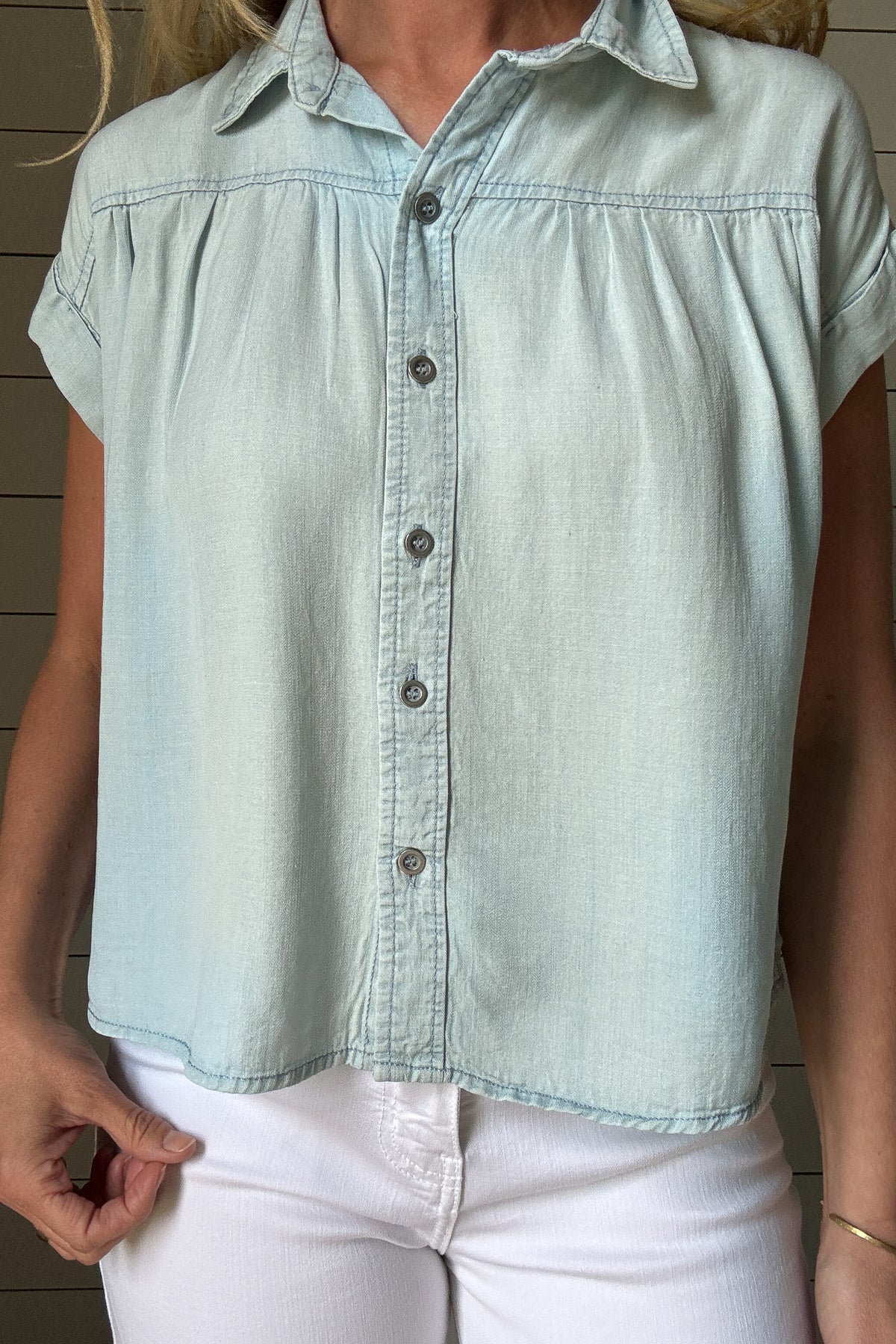 This button-front Tencel top is an easy grab for everyday style. Soft, breathable, and lightweight, it drapes beautifully and gives a polished look without any effort. Designed with a classic collar, full front buttons, and subtle side slits for a relaxed fit, it moves with you and hits just at the hips for a flattering finish. 