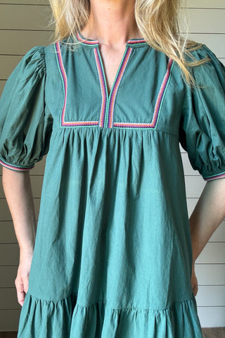 The Meadow Tiered Dress is a breezy, feminine style made for easy days. Crafted from 100% cotton, it’s soft, breathable, and perfect for warmer weather. This knee-length dress features three unlined tiers that create movement and a relaxed shape. The standout details are in the sleeves and neckline—billowed sleeves with a dramatic puff and delicate straight-line embroidery that adds a touch of texture and charm. The same embroidery traces the neckline for a finished, elevated look. Did we mention she has po