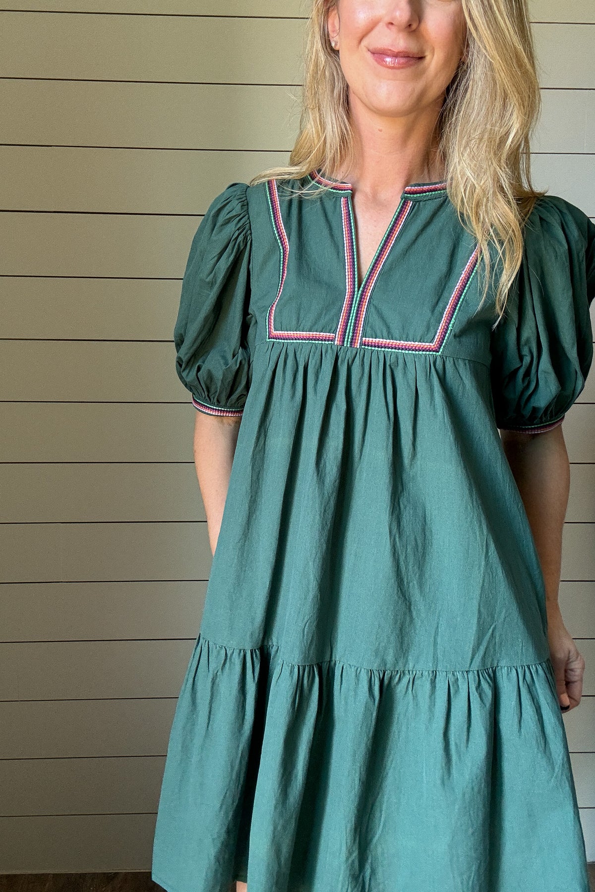 The Meadow Tiered Dress is a breezy, feminine style made for easy days. Crafted from 100% cotton, it’s soft, breathable, and perfect for warmer weather. This knee-length dress features three unlined tiers that create movement and a relaxed shape. The standout details are in the sleeves and neckline—billowed sleeves with a dramatic puff and delicate straight-line embroidery that adds a touch of texture and charm. The same embroidery traces the neckline for a finished, elevated look. Did we mention she has po