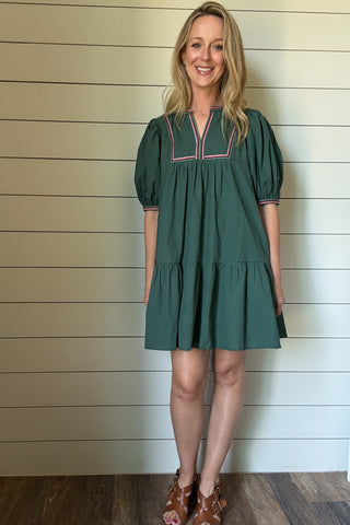 The Meadow Tiered Dress is a breezy, feminine style made for easy days. Crafted from 100% cotton, it’s soft, breathable, and perfect for warmer weather. This knee-length dress features three unlined tiers that create movement and a relaxed shape. The standout details are in the sleeves and neckline—billowed sleeves with a dramatic puff and delicate straight-line embroidery that adds a touch of texture and charm. The same embroidery traces the neckline for a finished, elevated look. Did we mention she has po