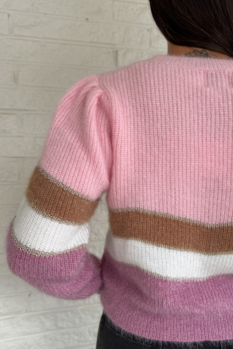 Soft and playful, this zigzag striped sweater adds a cheerful pop of color to your fall lineup. Designed with subtle shoulder gathers and a touch of shimmer in the thread, it blends comfort with a hint of fun. The mix of pink, ivory, and taupe tones makes it an easy piece to dress up or keep casual.
