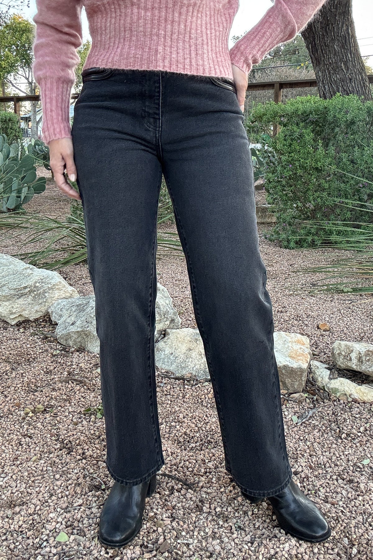 Women's charcoal black high-waisted jeans featuring a contrasting black faux leather waistband and front pocket detailing. Shop Cotton & Cashmere Boutique.
