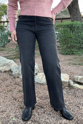 Women's charcoal black high-waisted jeans featuring a contrasting black faux leather waistband and front pocket detailing. Shop Cotton & Cashmere Boutique.