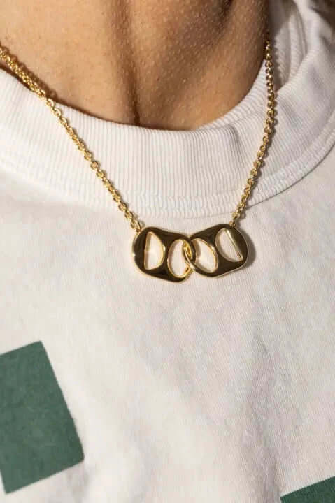 A statement that's simple, yet bold. Our Soda Tab Necklace is locked intertwined between two soda tabs interlinking at the center of the necklace. Add this piece to any necklace stack to create a bold or simple jewelry stack.

Made in USA