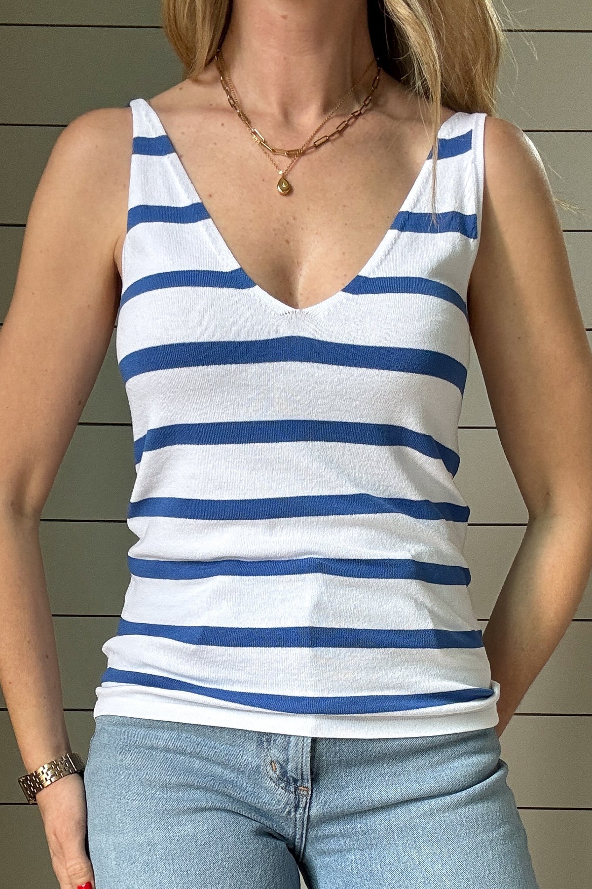 This blue and white striped knit tank is a fun, versatile piece you’ll wear on repeat! Slightly fitted for a flattering shape, it features a deep V-neckline in both the front and back, adding a feminine, breezy touch. The lightweight knit fabric feels soft and breathable, making it perfect for warm days or layering under your favorite denim jacket. The classic blue stripes against white make it easy to pair with anything from denim shorts to linen pants. Whether you’re headed out for a casual day or want so