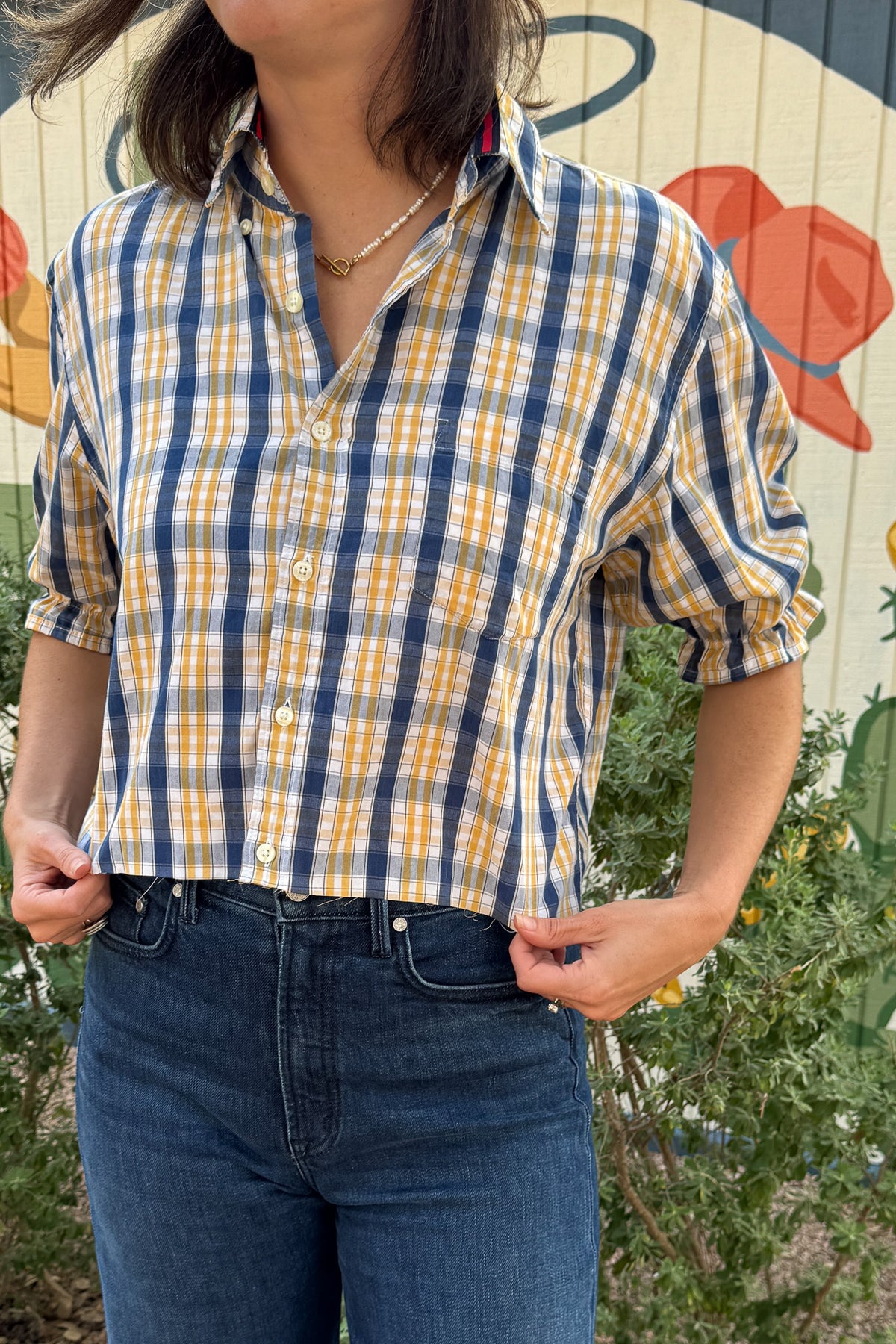 Women’s VonVie Stella top in navy, mustard, and white plaid with a cropped fit, button front, and ruffle sleeves.