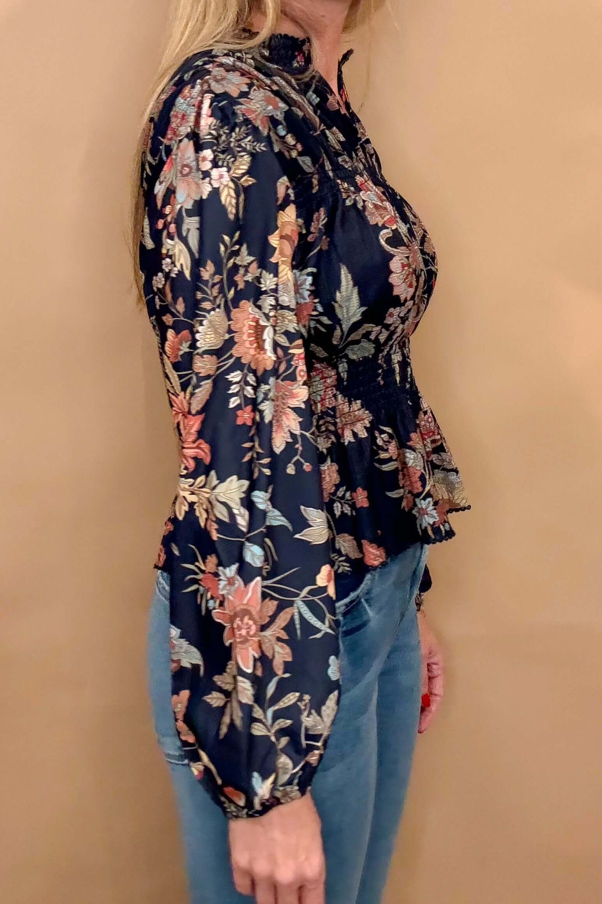 Embrace elegance and femininity with our Navy Floral Peplum. Featuring a split neck, delicate shoulder details, and gathered cuffs, peplum hem, this blouse is made from gorgeous floral fabric. Elevate your style and feel confident in this must-have piece.