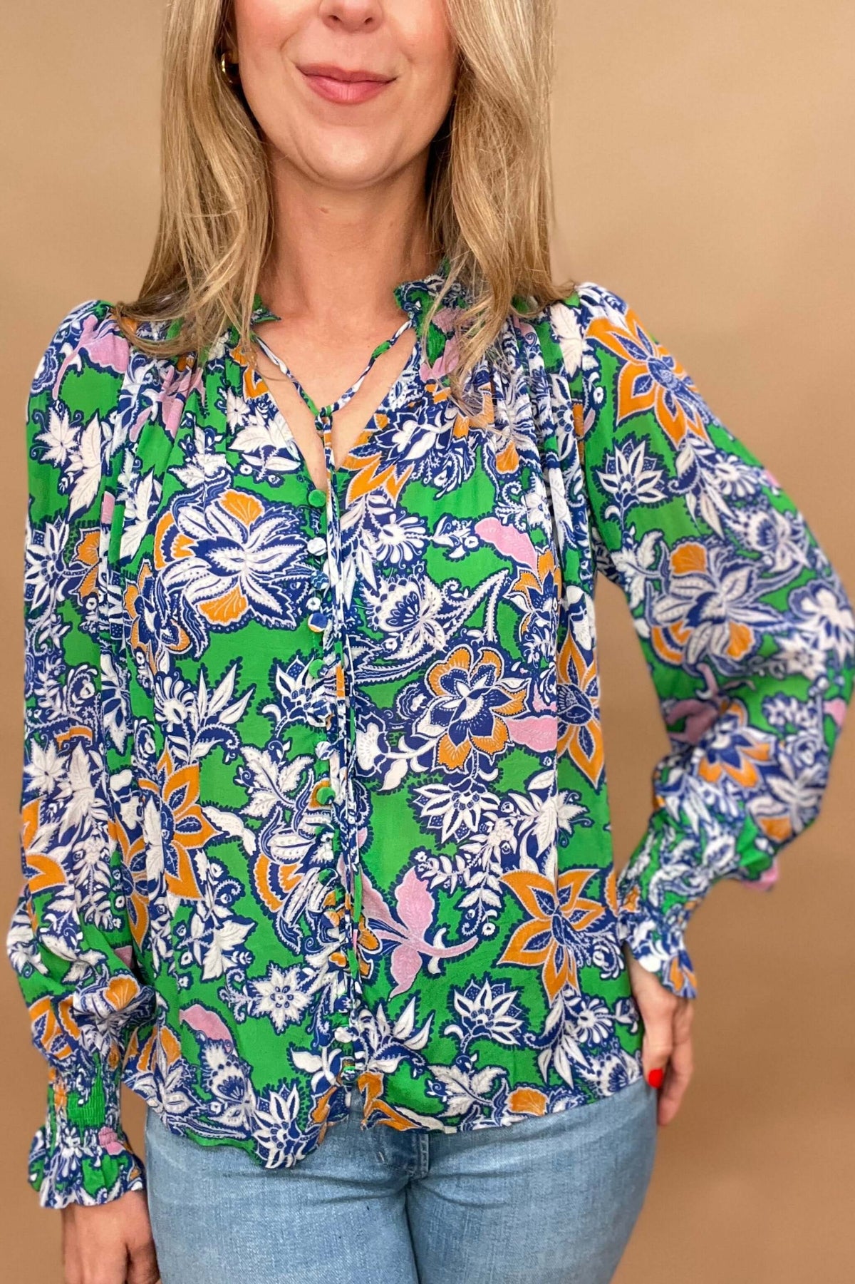 This lightweight and colorful fabric offers a playful twist with ruffled neckline and cuffs, tied neckline, and ever so slightly puffed shoulders.

The lightweight material is perfect for warmer days.&nbsp;

The fabric covered buttons, ruched detailing on the neckline &amp; cuffs adds an extra touch of elegance.