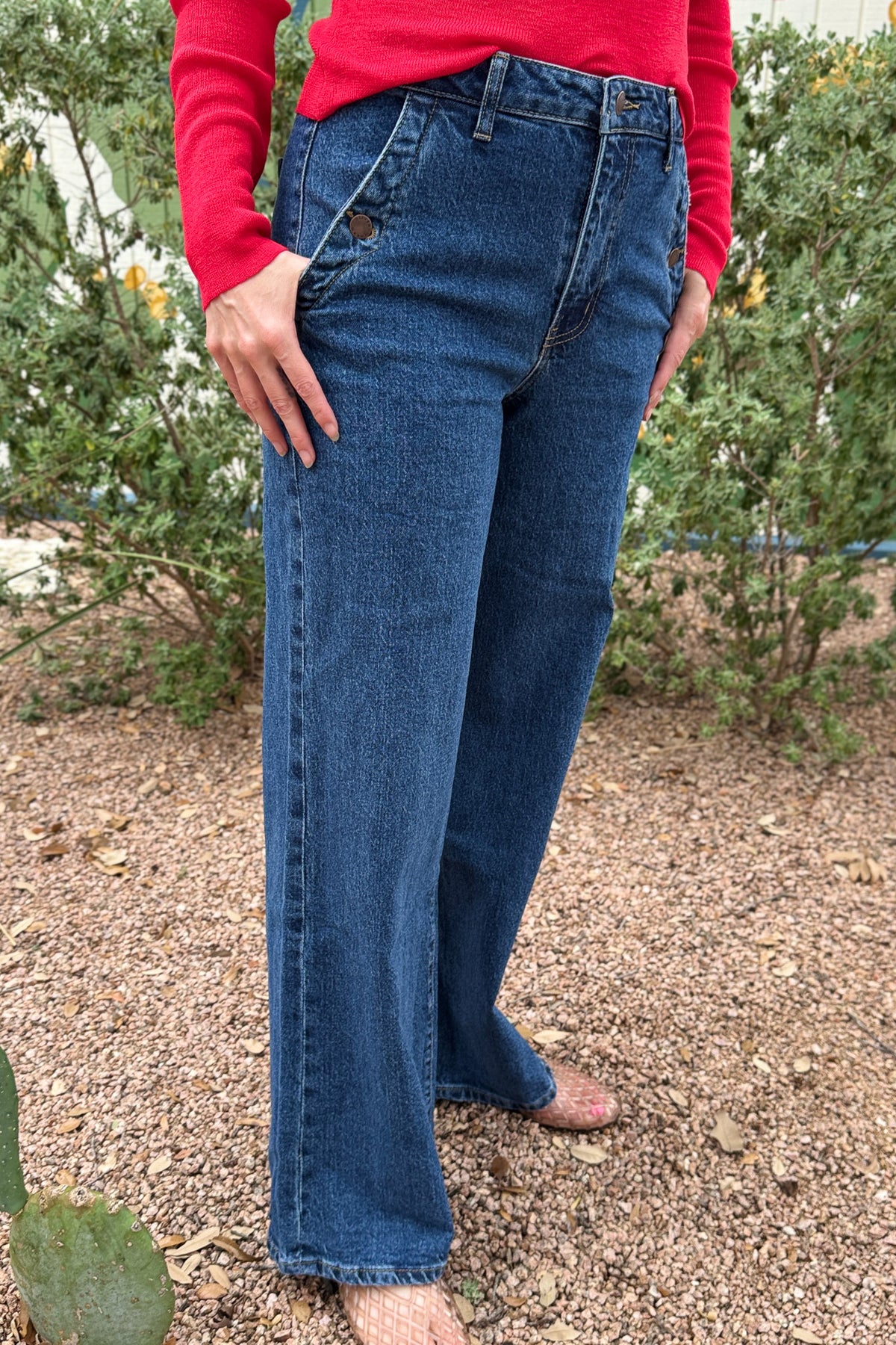 Women’s dark wash high rise wide leg jeans with button detail front pockets at Cotton & Cashmere in Blanco Texas