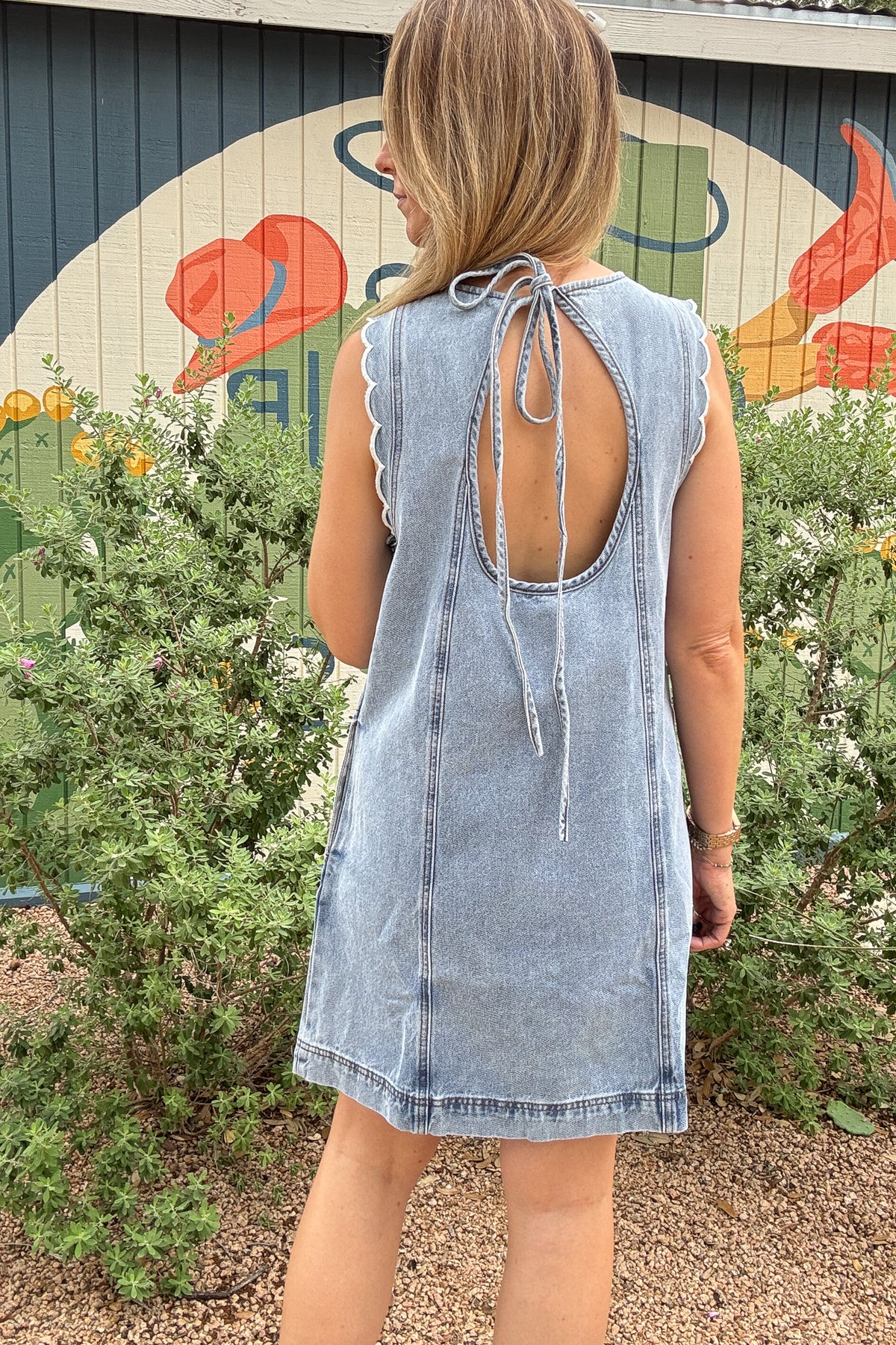 FRNCH 100% cotton denim dress with scalloped shoulder details, side pockets, and tie-back detail at Cotton and Cashmere in Blanco Texas

Sleeveless FRNCH denim dress made from 100% cotton with scalloped shoulders, relaxed fit, pockets, and open tie-back detail

Light wash cotton denim dress by FRNCH with scalloped shoulder trim, side pockets, and easy shift-style fit

FRNCH women’s cotton denim dress with feminine scalloped shoulders, tie-back opening, and pockets for effortless everyday style