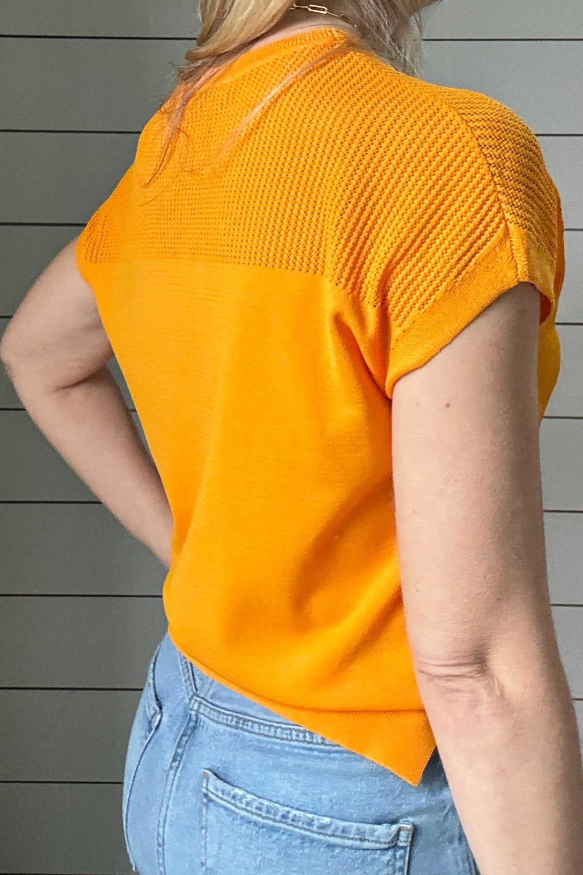 Elevate your spring style with our Orange Crush Knit Top by Current Air.&nbsp;The open weave design over the shoulders and upper chest adds a touch of lightness to this vibrant and fun top. Lightweight, stretchy and layer-able, this top will brighten up your outfit &amp; day!