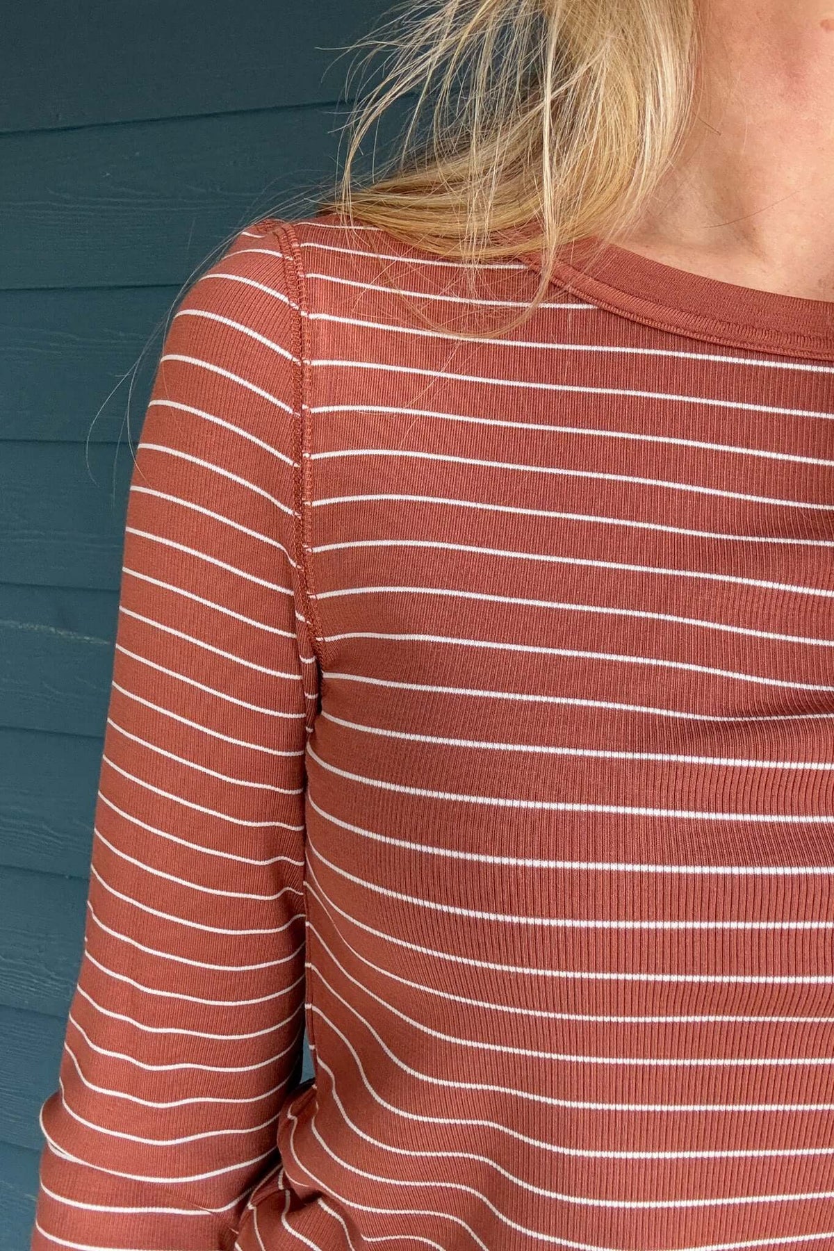 Experience the timeless beauty of the Ecru &amp; Rust Striped Knit Top. This exquisite piece of knitwear features an ecru and rust striped design, with a rounded hem for effortless layering. Its premium construction offers long-lasting quality and comfort.