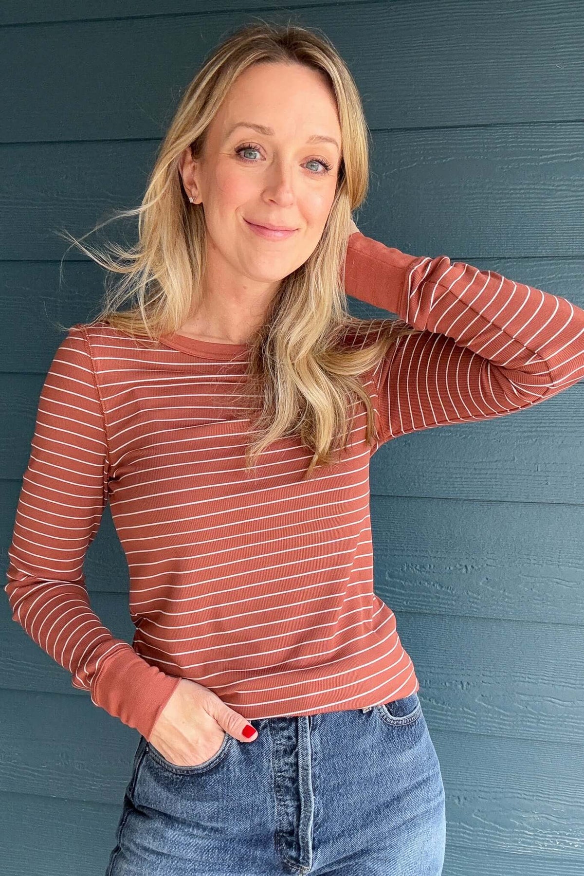 Experience the timeless beauty of the Ecru &amp; Rust Striped Knit Top. This exquisite piece of knitwear features an ecru and rust striped design, with a rounded hem for effortless layering. Its premium construction offers long-lasting quality and comfort.