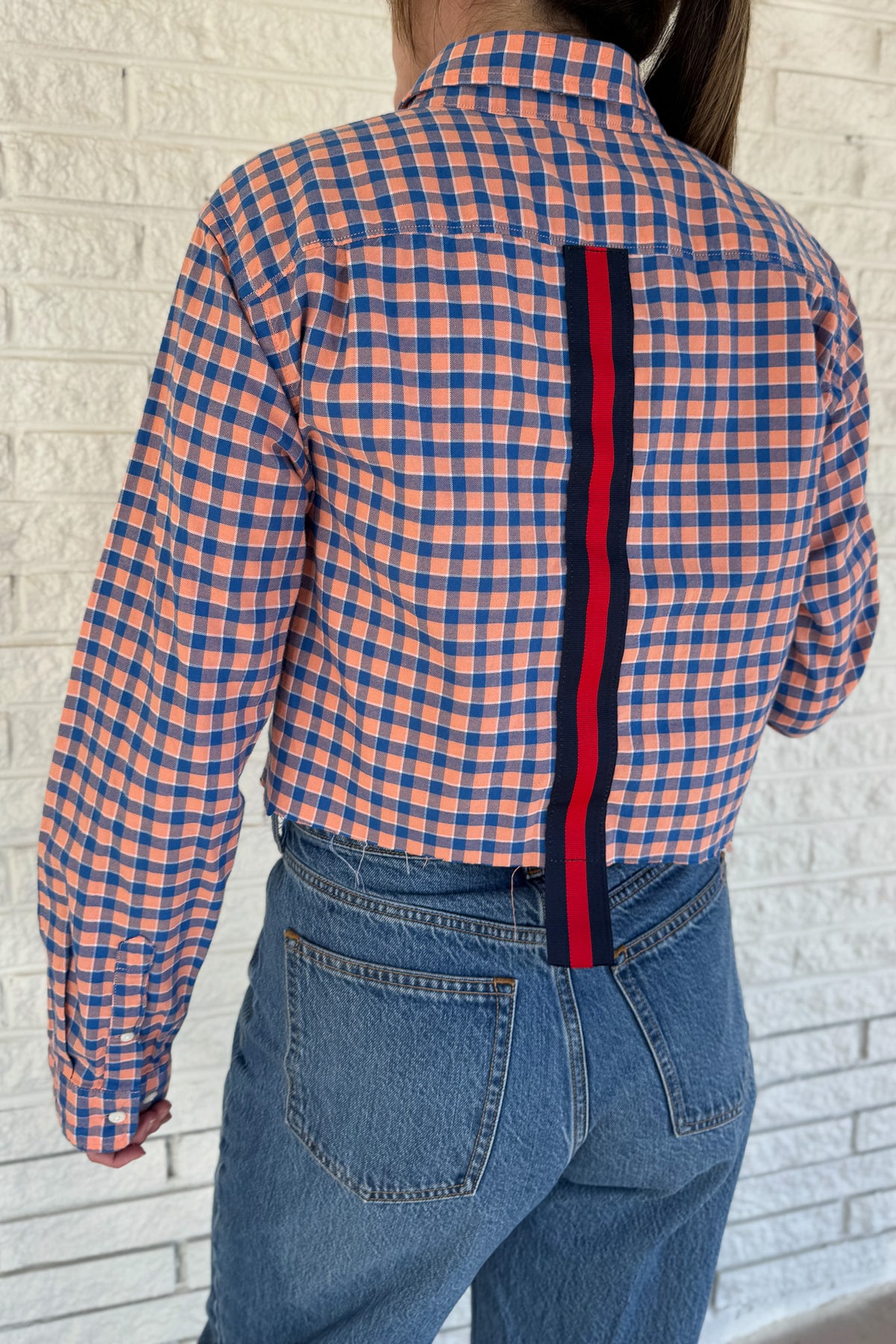 An upcycled men’s shirt reworked into a cropped, raw hem, easy silhouette that feels fresh and relaxed. Soft, feminine, and one-of-a-kind. Designed to be a one size fits most when worn open, wear it buttoned up and it fits like small or medium.