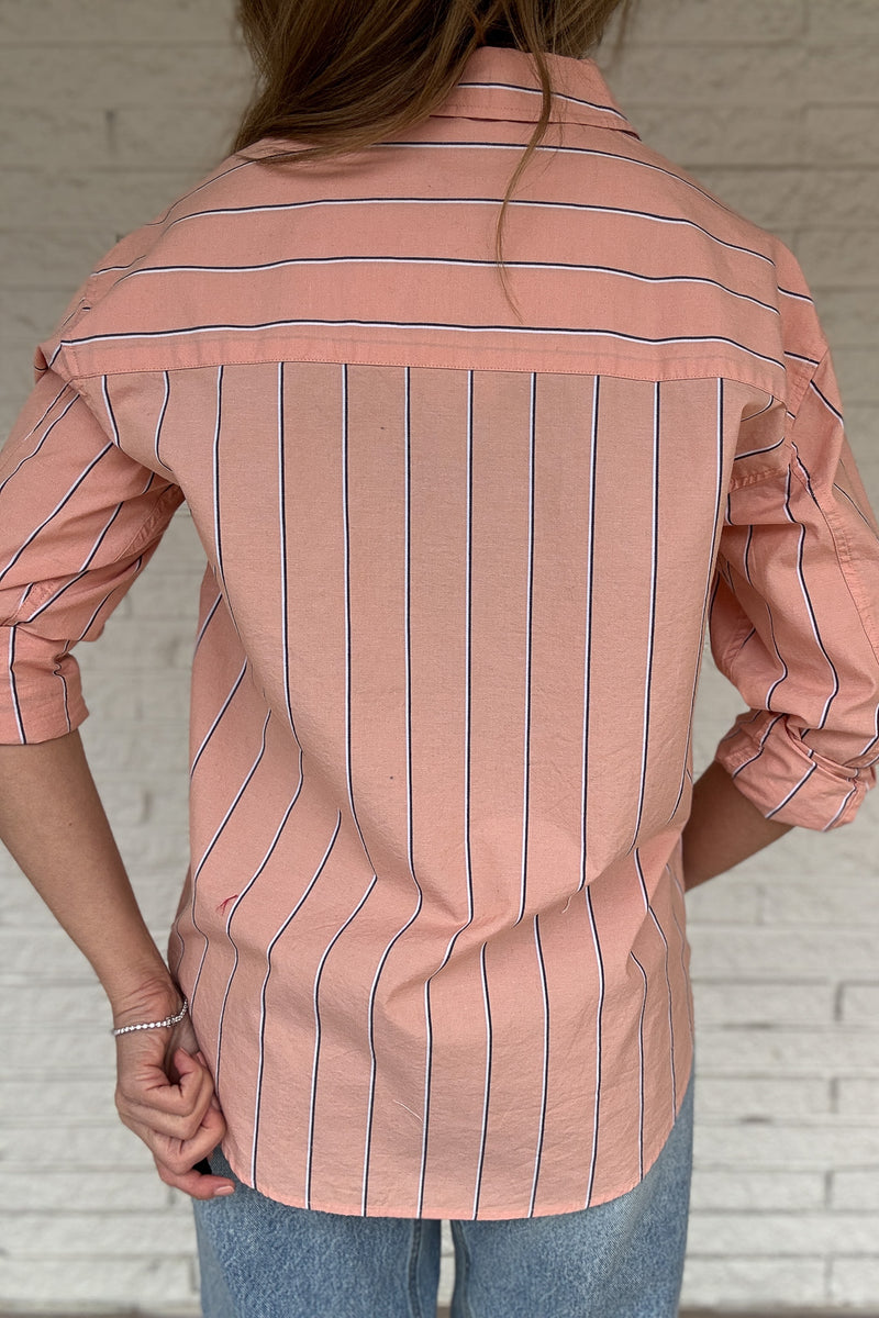 This striped button-down is an easy, everyday staple you’ll reach for on repeat. Made from breathable 100% cotton, it has a relaxed feel with a polished look that works tucked, tied, or worn open over a tee. The peach tone and vertical stripe keep it flattering and effortless from workdays to weekends.

Women's fashion boutique Blanco Texas Johnson City Texas