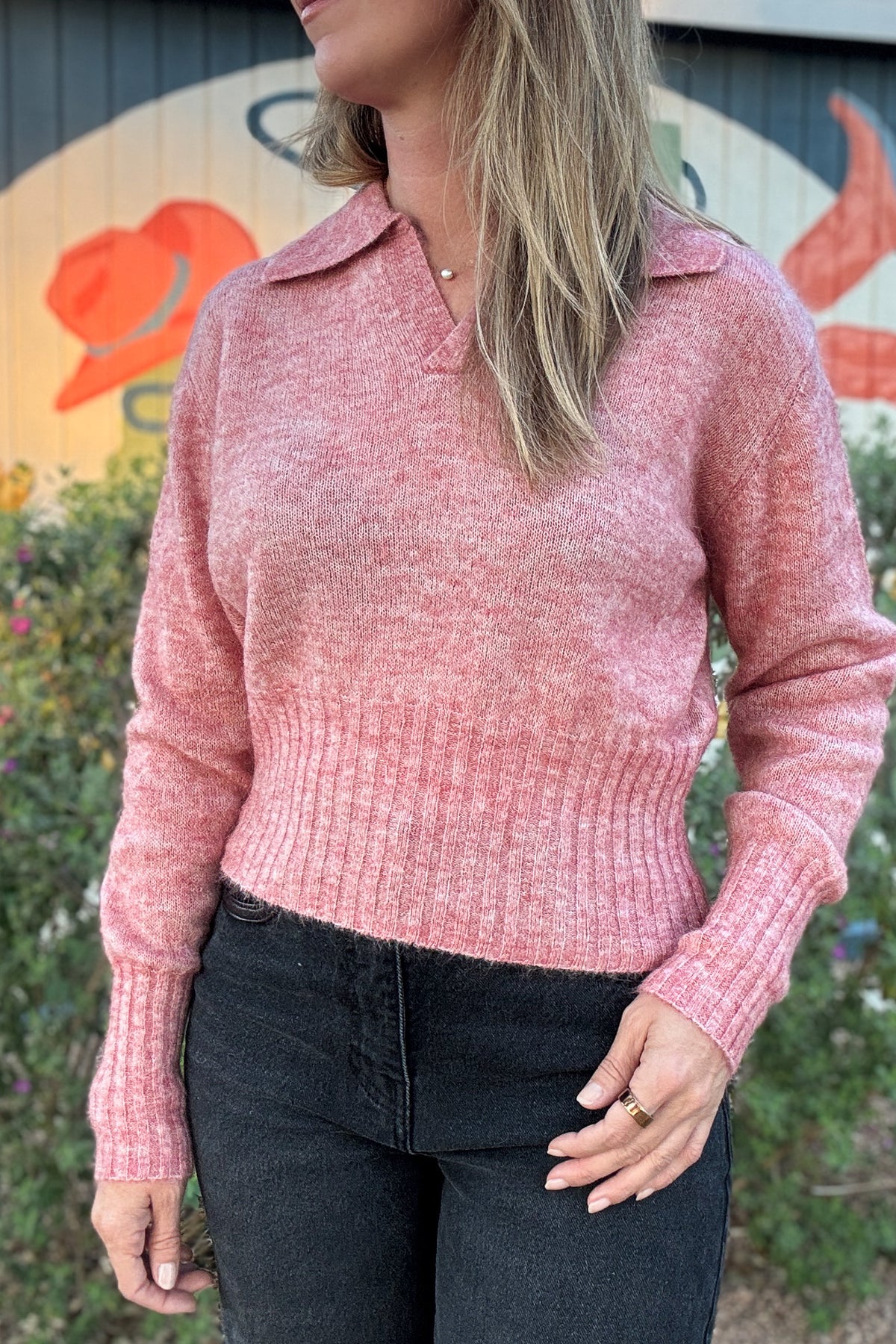 Soft pink pullover sweater for women featuring a relaxed fit, classic polo collar, and wide ribbed hem and cuffs.