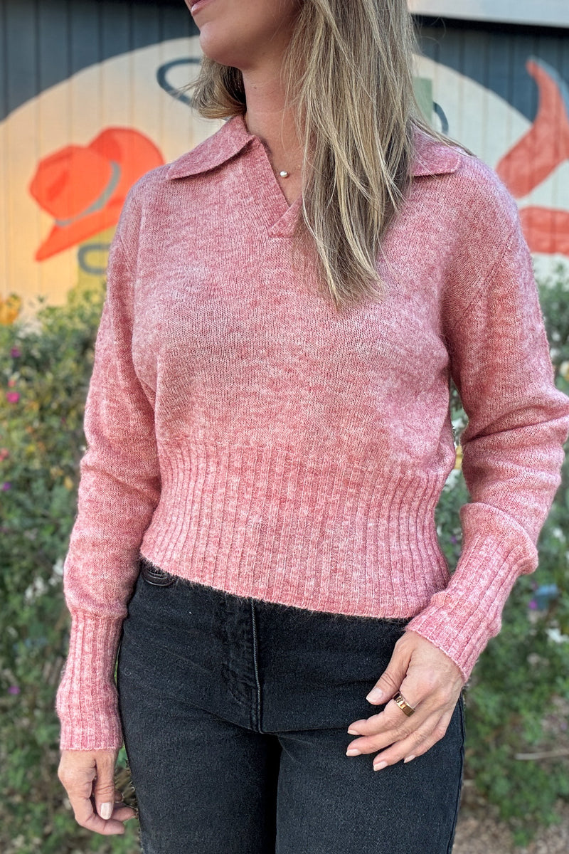 Soft pink pullover sweater for women featuring a relaxed fit, classic polo collar, and wide ribbed hem and cuffs.
