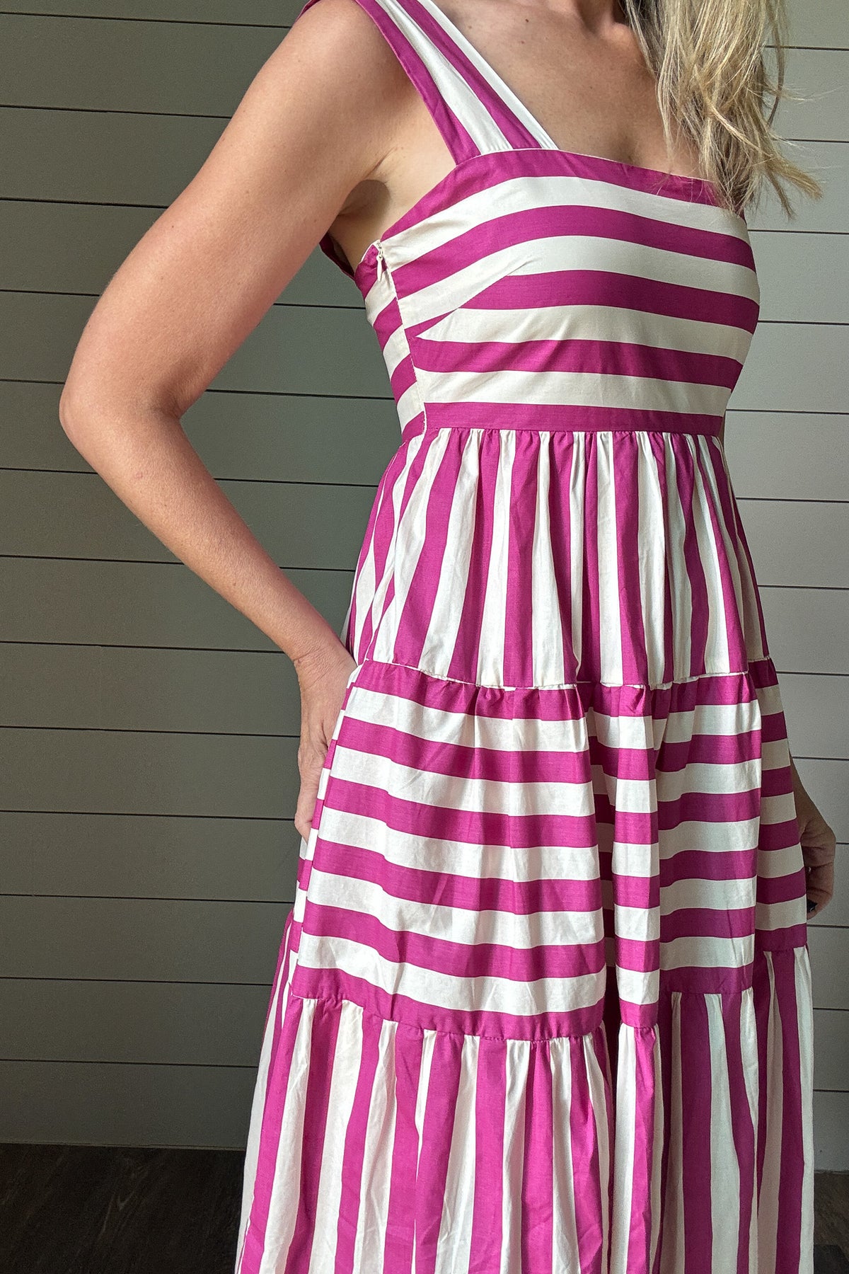 &nbsp;This dress brings all the joy. With bold pink and white stripes and a playful tiered skirt, it’s made for sunshine and smiles. The wide straps and square neckline give it a flattering, modern shape while the lined cotton fabric keeps it breezy and comfortable. No pockets means a smooth, easy fit—just add sandals and go.