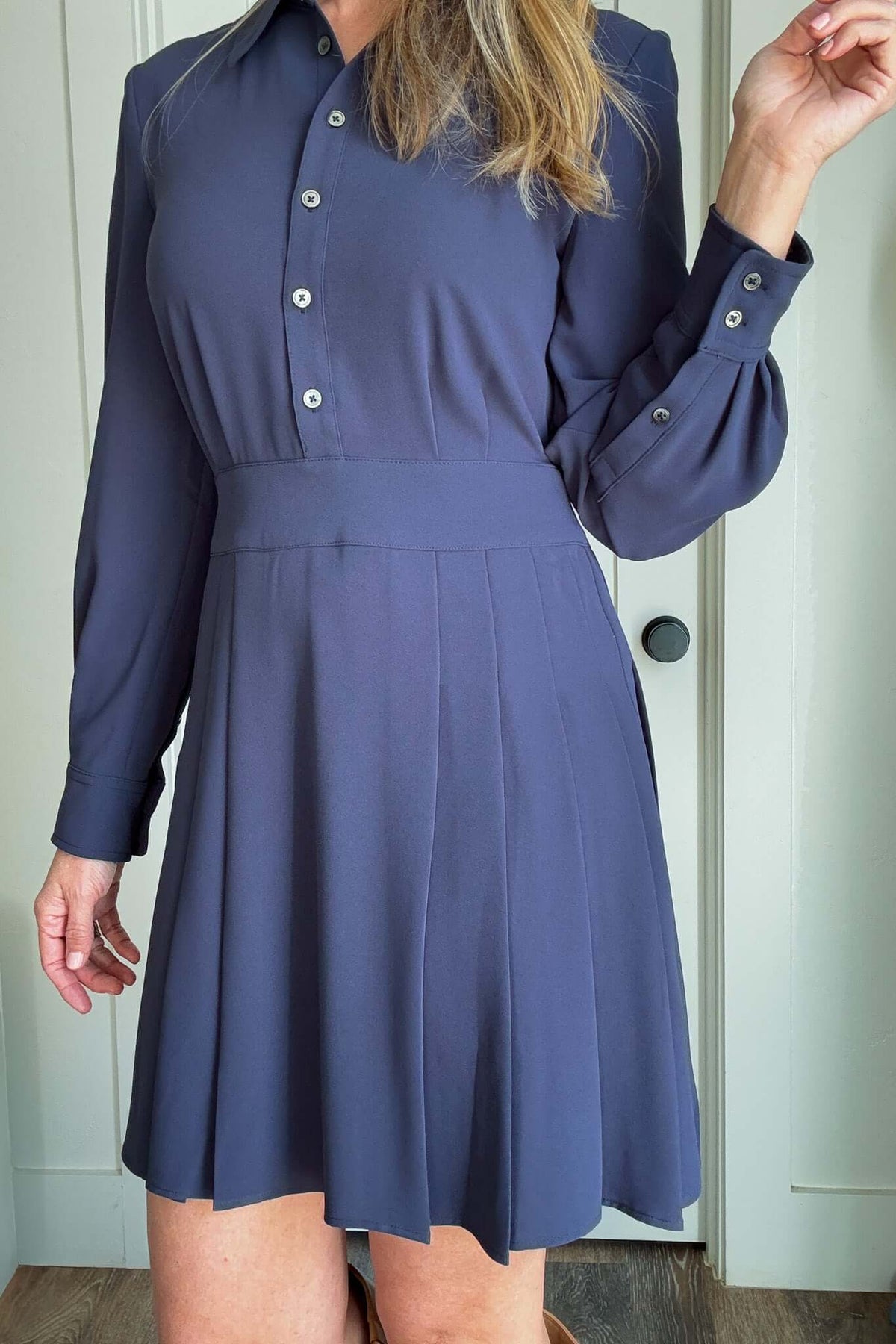 Elevate your style with our Pleated Skirt Dress! Featuring a button-up top and a pleated skirt that hits above the knee for a flattering look. The hidden zipper under the arm provides seamless wear, while the flowy and heavy weight fabric ensures comfort and eliminates the need for lining. Experience the perfect mix of function and fashion.