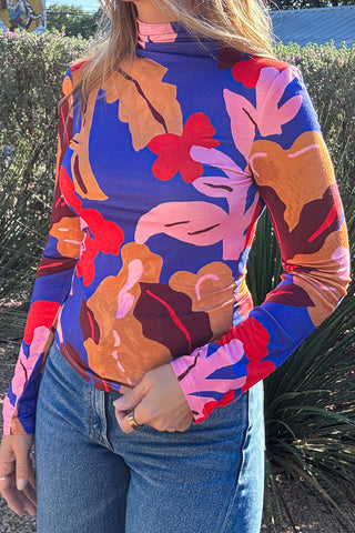 Women's printed mock neck top styled with blue denim jeans for an effortless everyday outfit. Shop Cotton & Cashmere in Blanco, Texas.