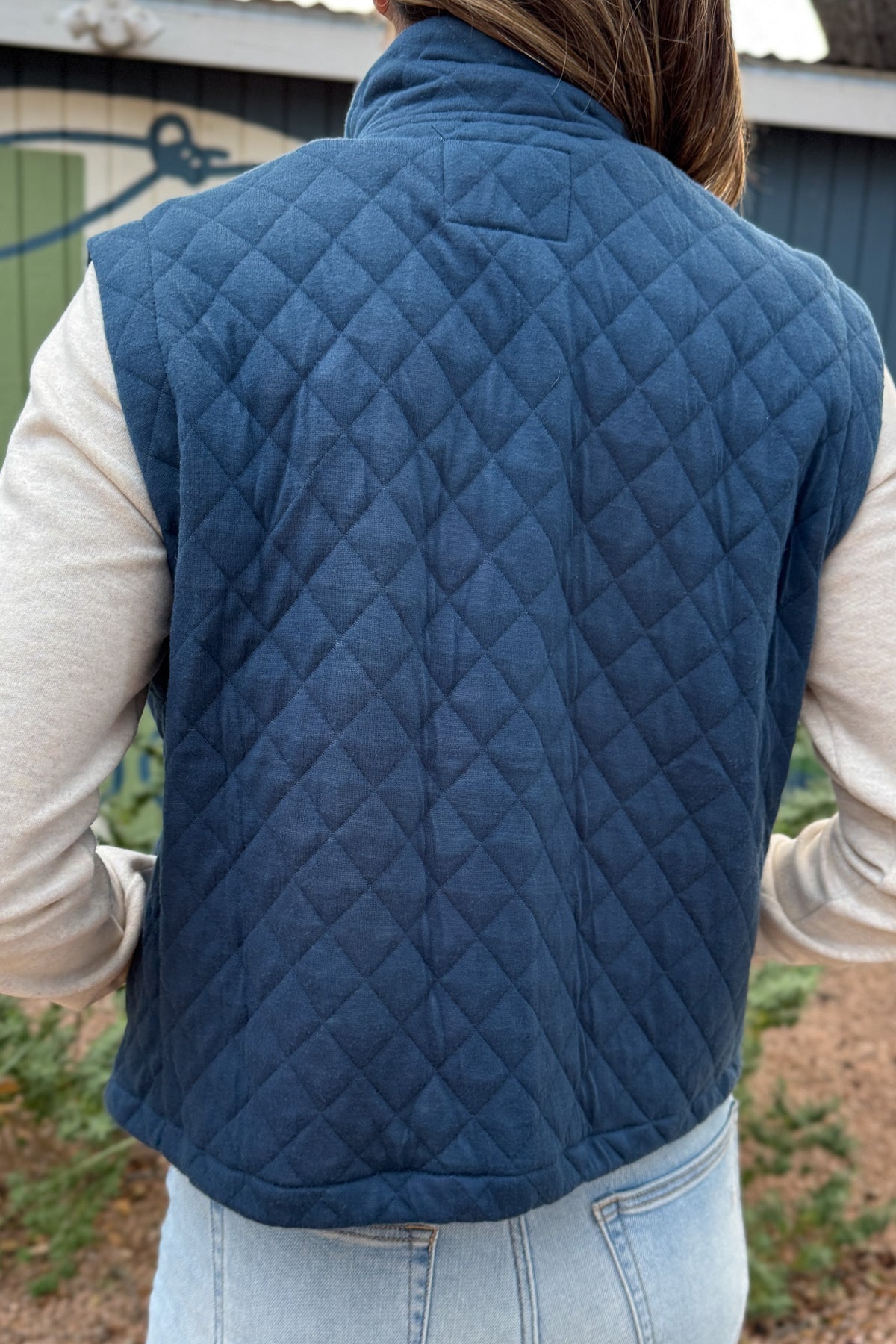 This quilted vest brings effortless layering to your everyday style. Designed in a classic navy hue with soft diamond stitching, it’s the perfect blend of warmth and versatility. The inside reveals a fun pop of color with a geometric print lining—making it just as cute zipped up as it is open.