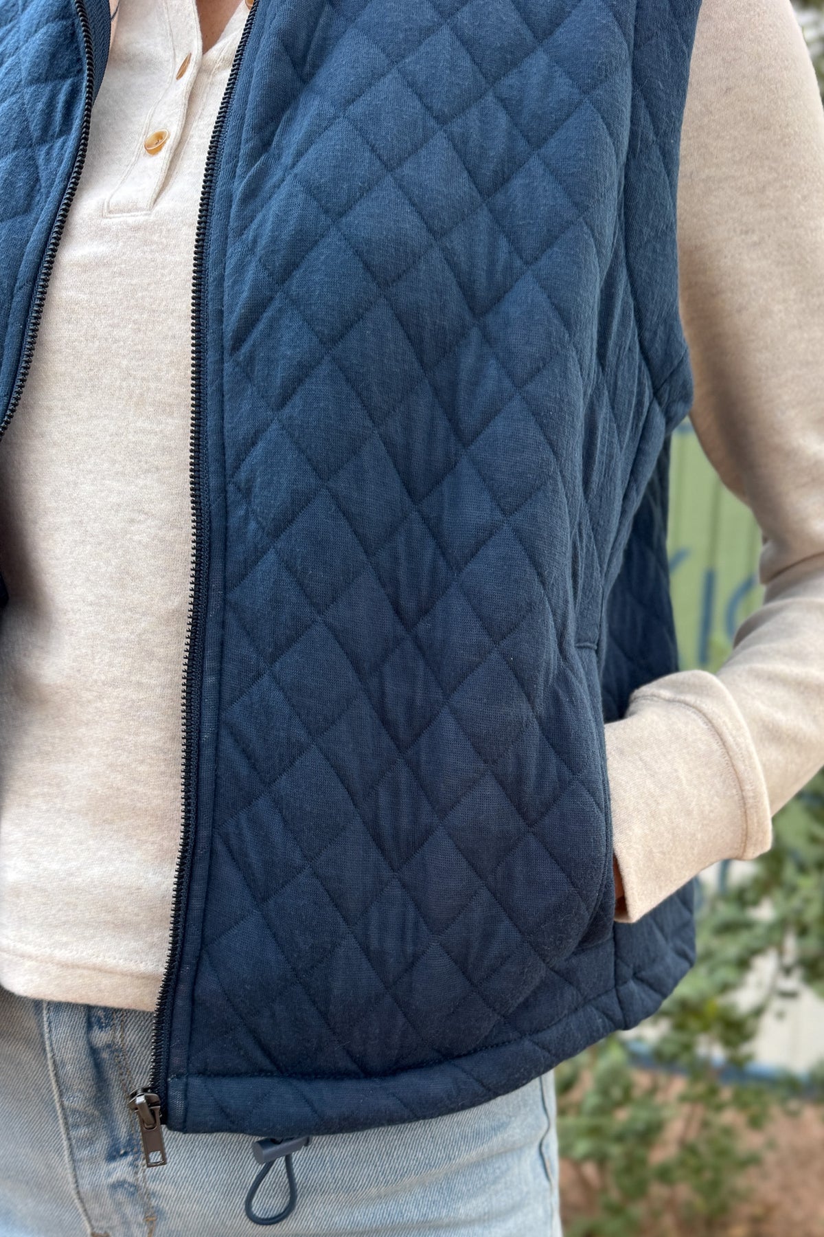 This quilted vest brings effortless layering to your everyday style. Designed in a classic navy hue with soft diamond stitching, it’s the perfect blend of warmth and versatility. The inside reveals a fun pop of color with a geometric print lining—making it just as cute zipped up as it is open.
