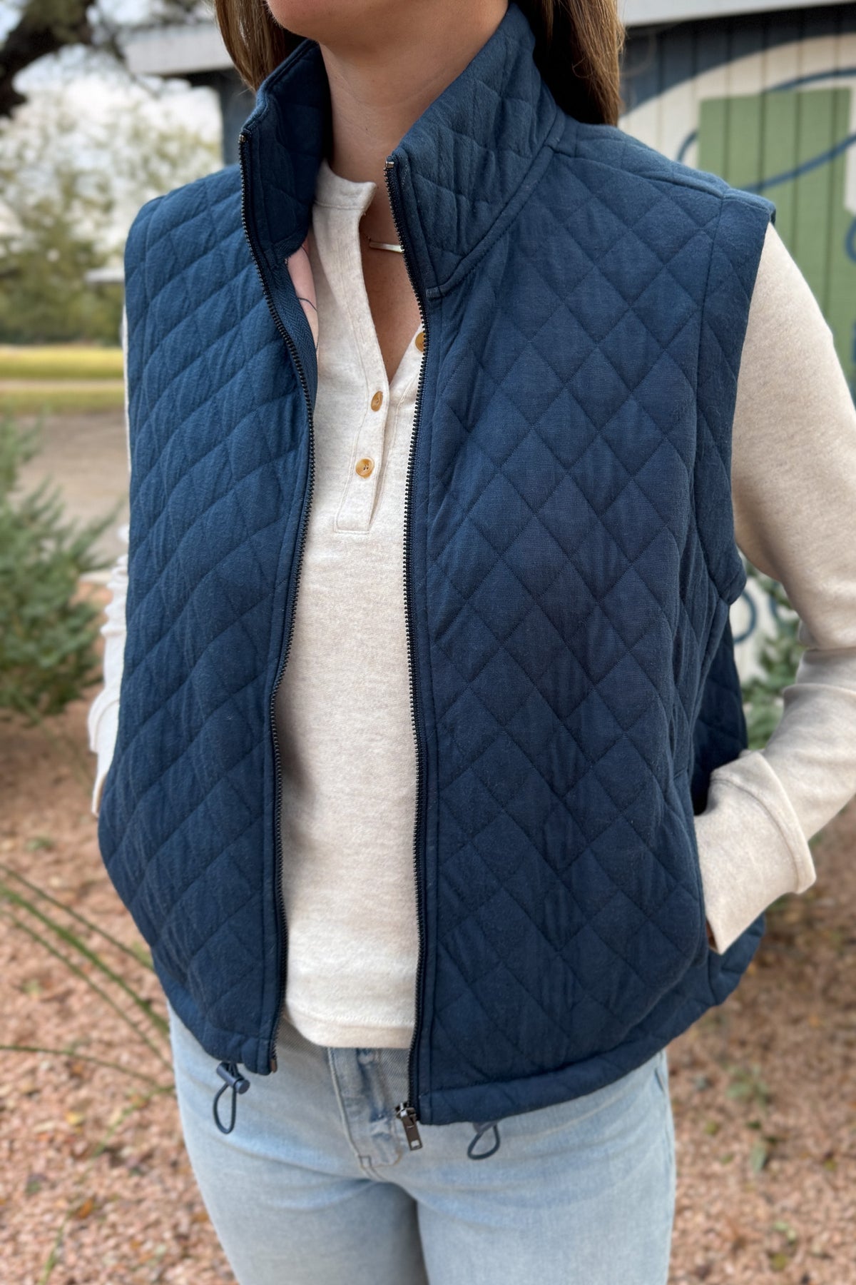 This quilted vest brings effortless layering to your everyday style. Designed in a classic navy hue with soft diamond stitching, it’s the perfect blend of warmth and versatility. The inside reveals a fun pop of color with a geometric print lining—making it just as cute zipped up as it is open.