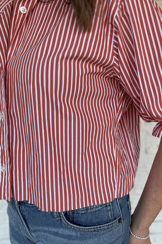An upcycled men’s shirt reworked into a (mom) crop, raw hem, easy silhouette that feels fresh and relaxed. The orange striped cotton keeps it classic while the slightly billowed sleeves add a fun twist. Soft, breathable, and one-of-a-kind. Designed to be a one size fits most, wear it buttoned up and it fits like an XS or small, wear it open and it fits size medium or large Women's fashion boutique Blanco Texas Johnson City Texas