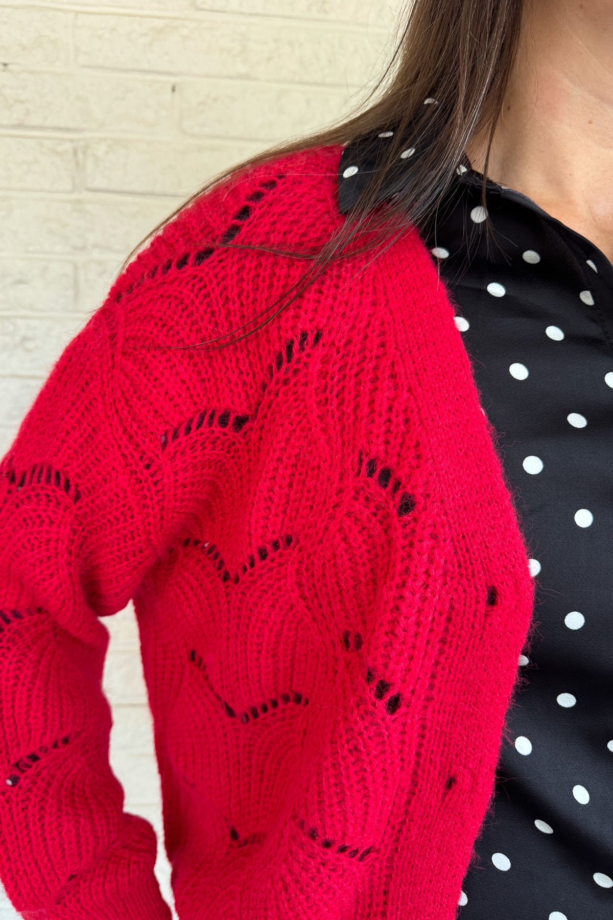 This openwork knit cardigan is a relaxed layer with an effortless drape. Designed in an oversized, straight cut with wide sleeves, it gives a cozy yet modern feel. The plunging V-neckline and metallic button closure add chic details that elevate this everyday piece.