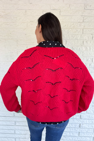This openwork knit cardigan is a relaxed layer with an effortless drape. Designed in an oversized, straight cut with wide sleeves, it gives a cozy yet modern feel. The plunging V-neckline and metallic button closure add chic details that elevate this everyday piece.