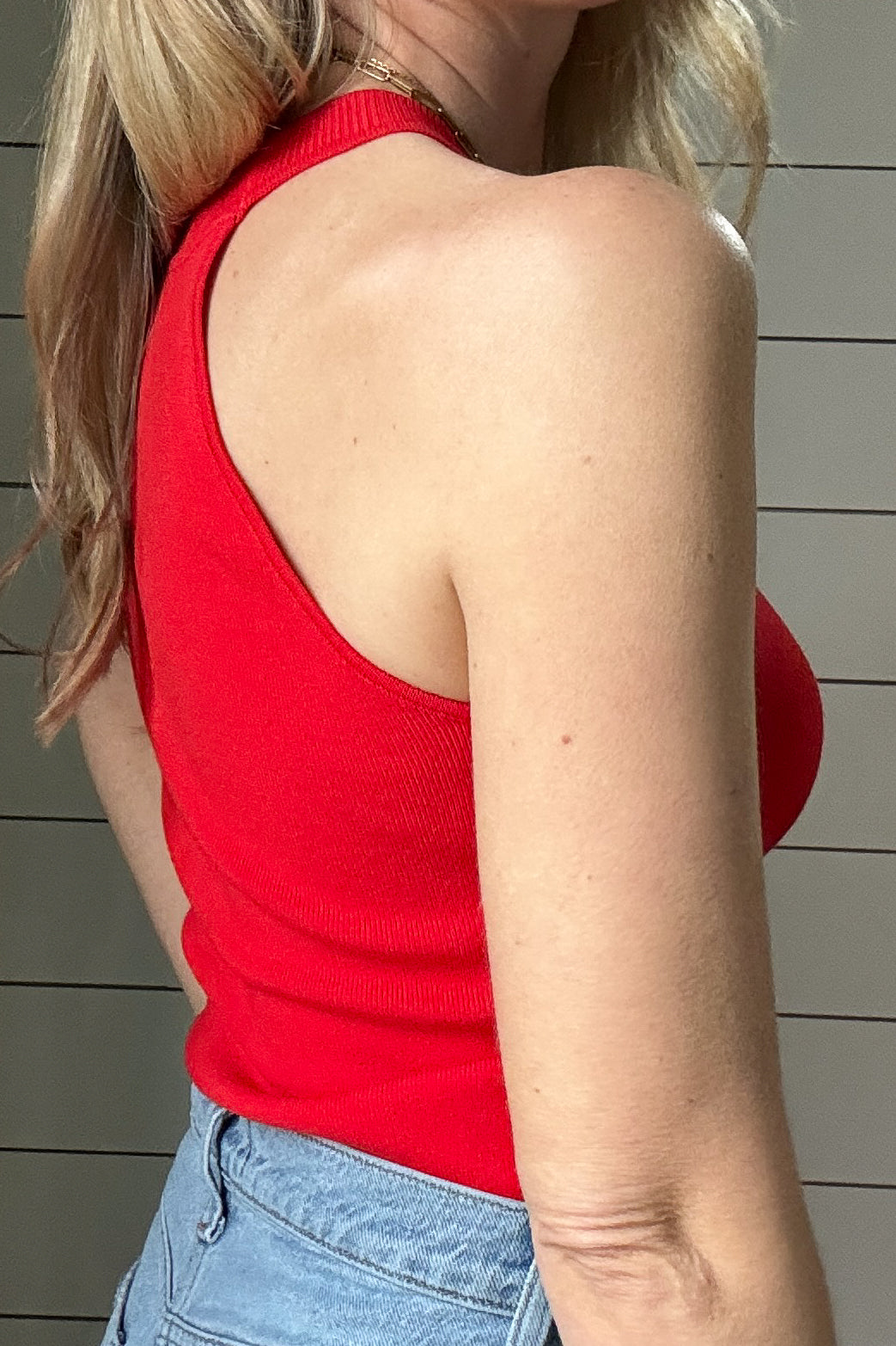 This fitted red knit halter top is an effortless closet essential! True to size, it hugs your curves in all the right places for a flattering silhouette. The high neckline and ribbed texture add a touch of elegance while keeping things casual enough for everyday wear. Whether paired with your favorite high-waisted jeans for a laid-back look or dressed up with a skirt, this versatile piece can do it all. The breathable knit fabric makes it comfortable enough for all-day wear, and its vibrant red color brings