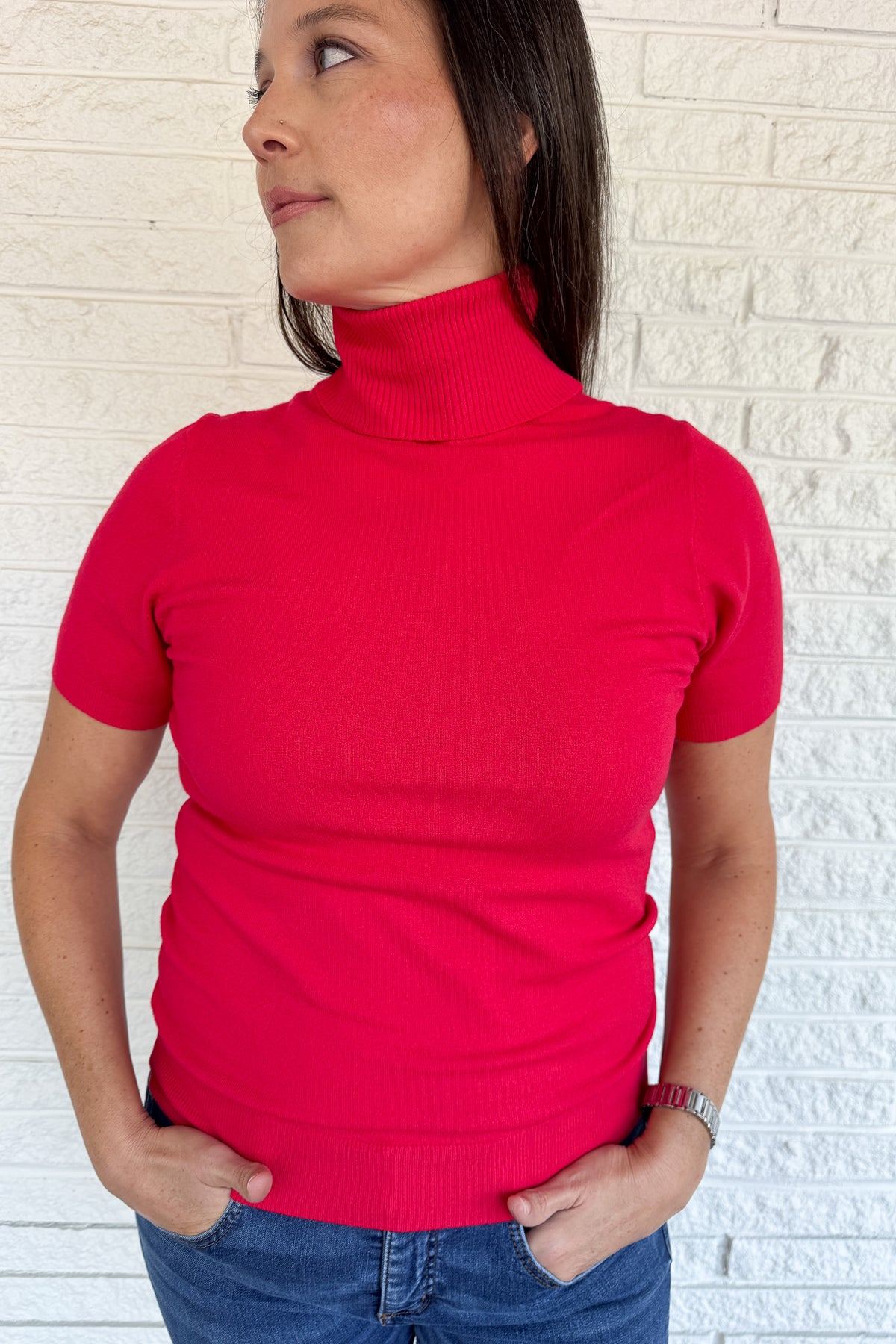 &nbsp;A modern twist on a classic silhouette, this short sleeve turtleneck sweater is sleek and versatile. The soft knit blend drapes comfortably while the fitted design makes it perfect for layering or wearing solo.