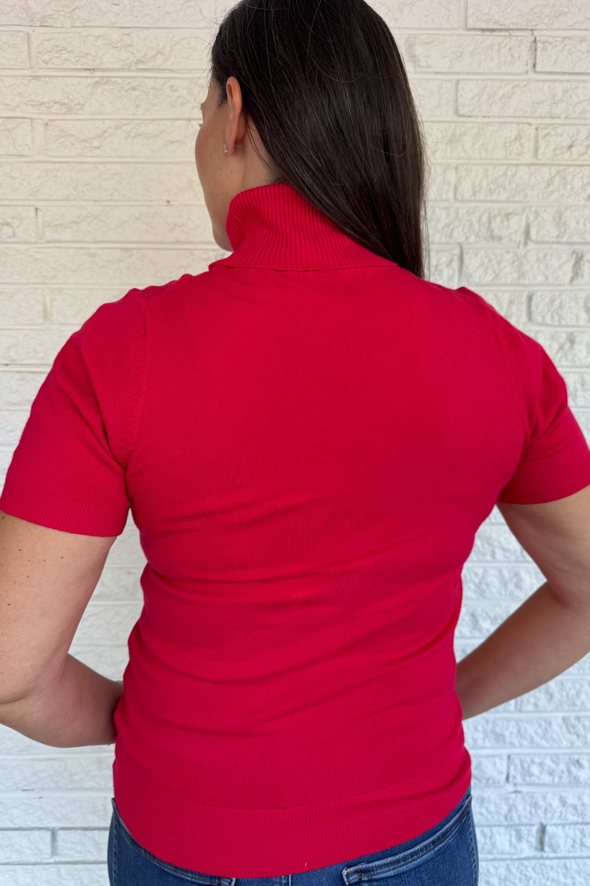 &nbsp;A modern twist on a classic silhouette, this short sleeve turtleneck sweater is sleek and versatile. The soft knit blend drapes comfortably while the fitted design makes it perfect for layering or wearing solo.