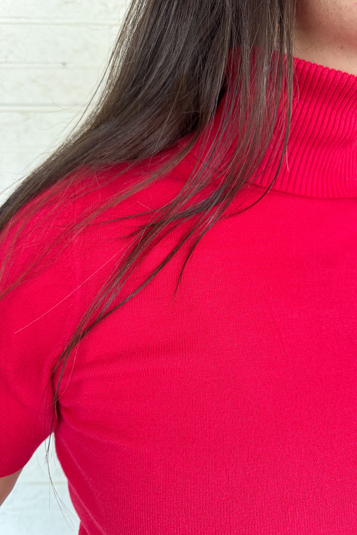 &nbsp;A modern twist on a classic silhouette, this short sleeve turtleneck sweater is sleek and versatile. The soft knit blend drapes comfortably while the fitted design makes it perfect for layering or wearing solo.