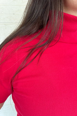 &nbsp;A modern twist on a classic silhouette, this short sleeve turtleneck sweater is sleek and versatile. The soft knit blend drapes comfortably while the fitted design makes it perfect for layering or wearing solo.